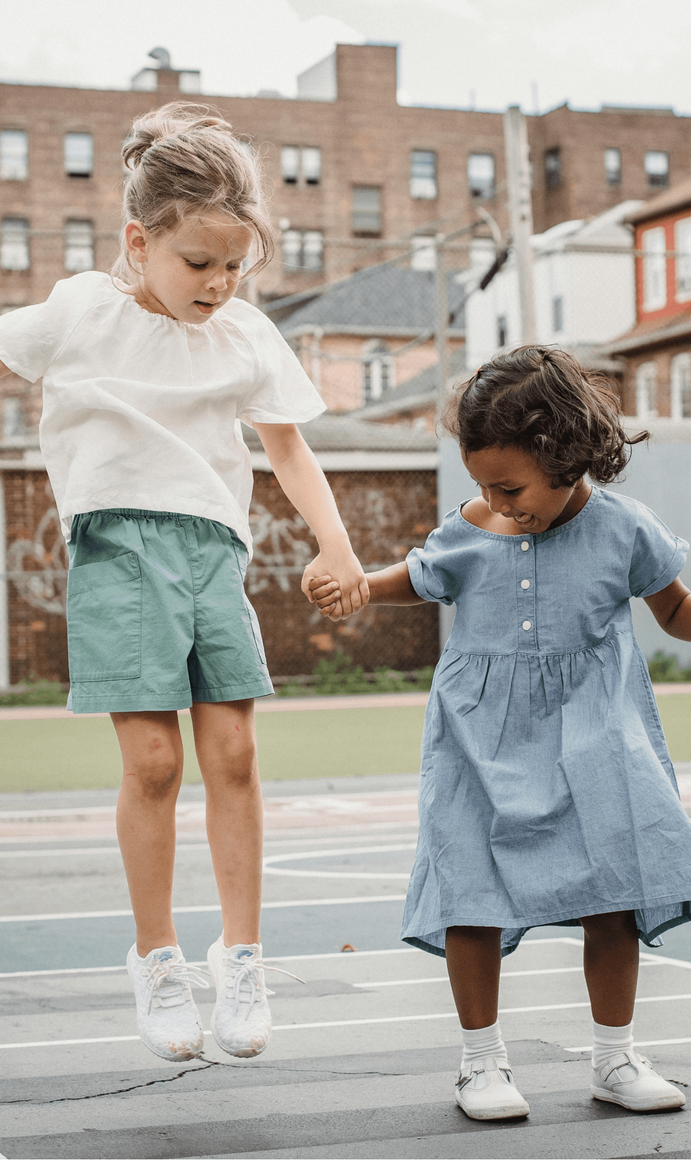 Two young girls jumping 