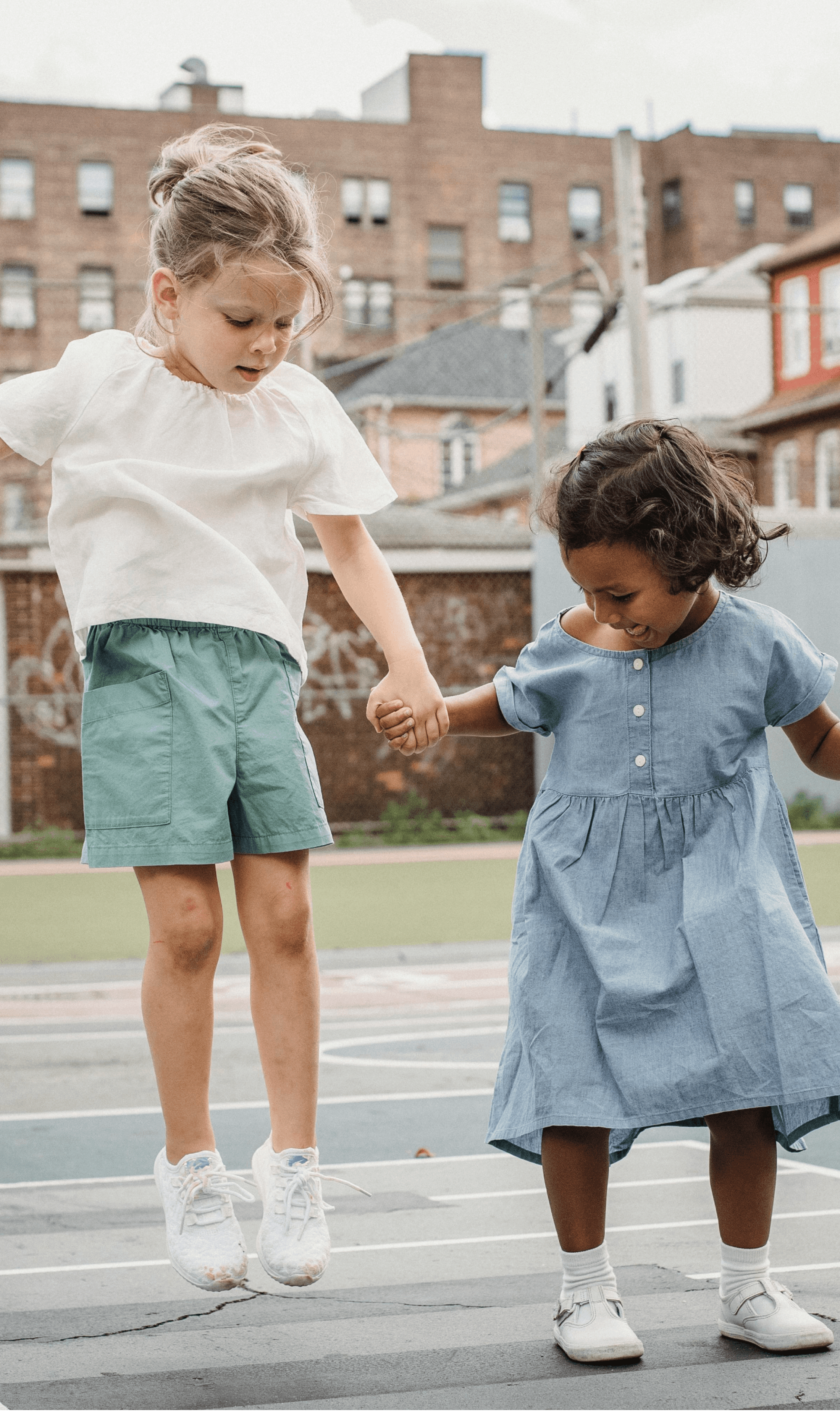 Two young girls jumping