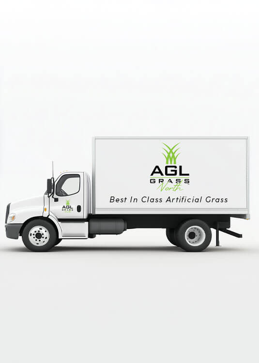 A white AGL Grass North delivery truck with the logo printed on the side of the bobtail and a tagline reading "Best in Class Artificial Grass."