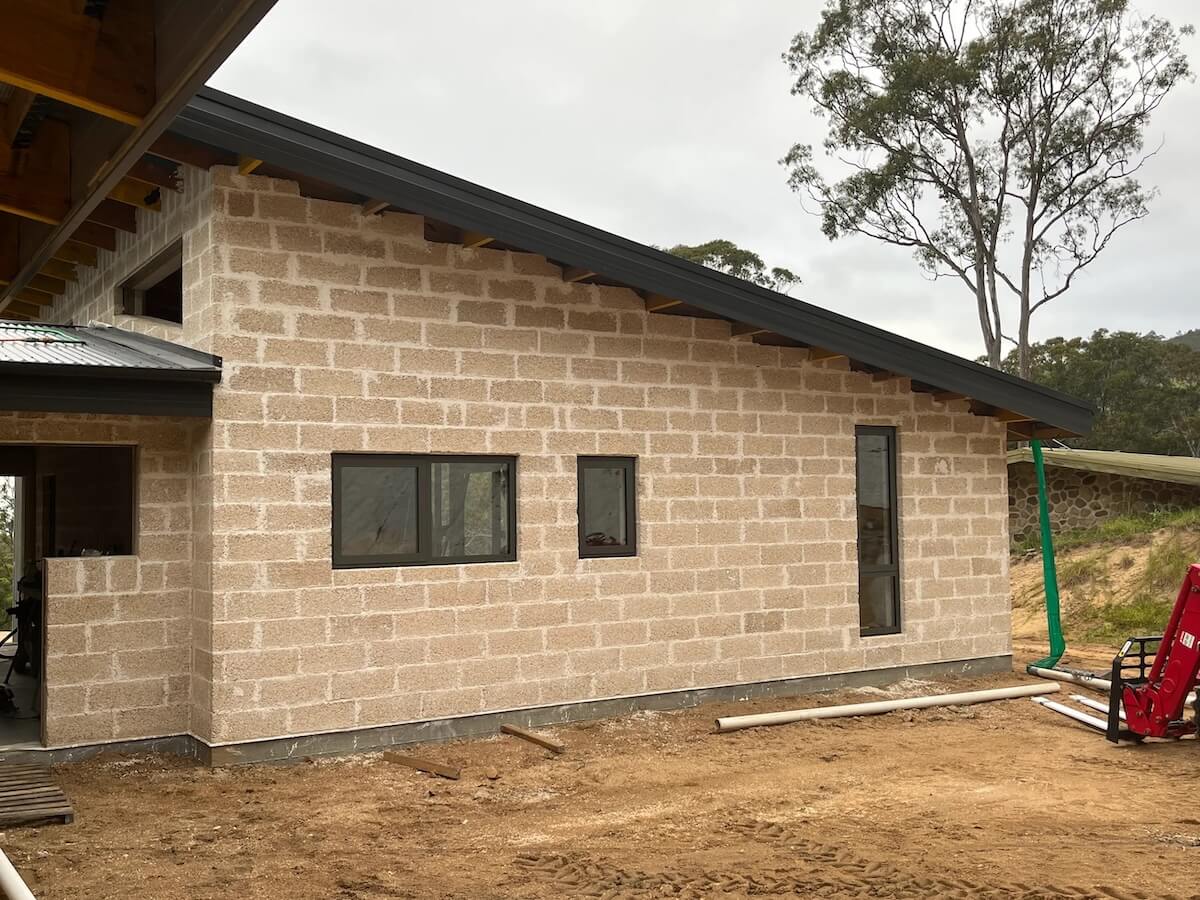 Image of a beautiful hemp block house showing the height of the walls and how the blocks have been used externally for good thermal performance. 