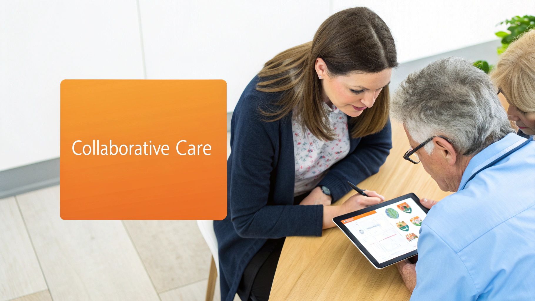 Three people, including a healthcare provider, engaged in collaborative care, reviewing information on a tablet.