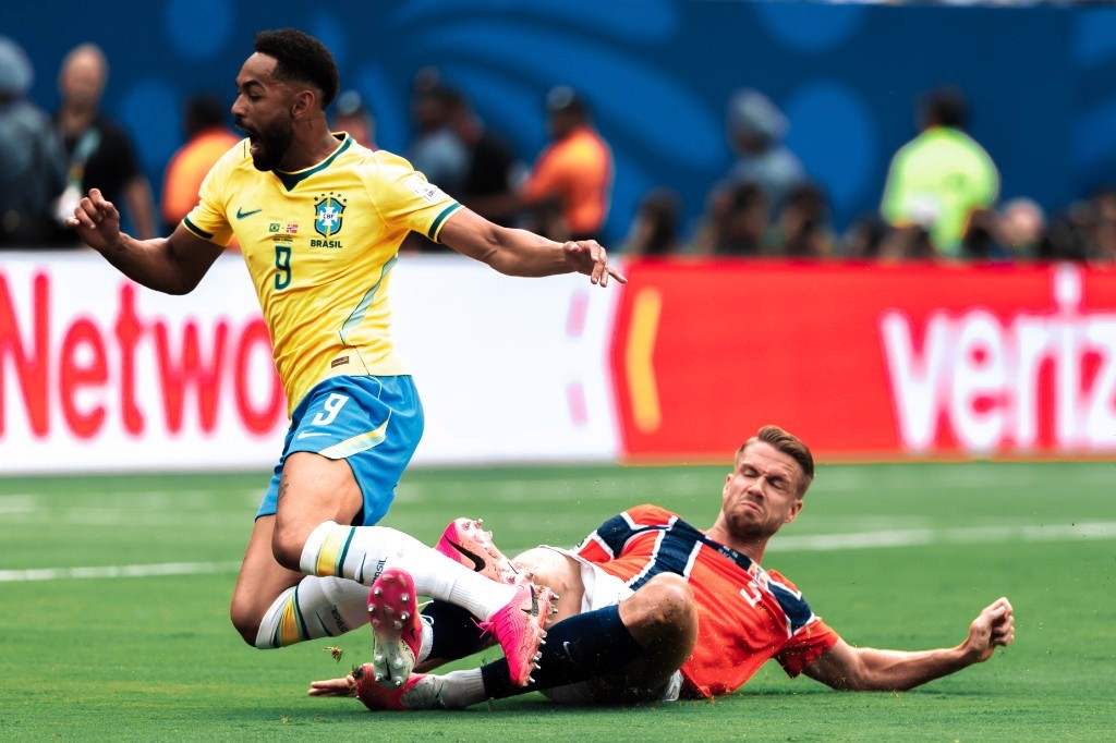 Brazil's number 9 leaps over a fallen Norway defender during their 2026 World Cup Round of 16 clash in New Jersey