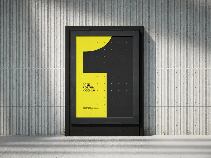 Outdoor poster mockup in a black frame, mounted on a textured concrete wall. The design features bold yellow and black colors, casting soft shadows for a modern, urban look.