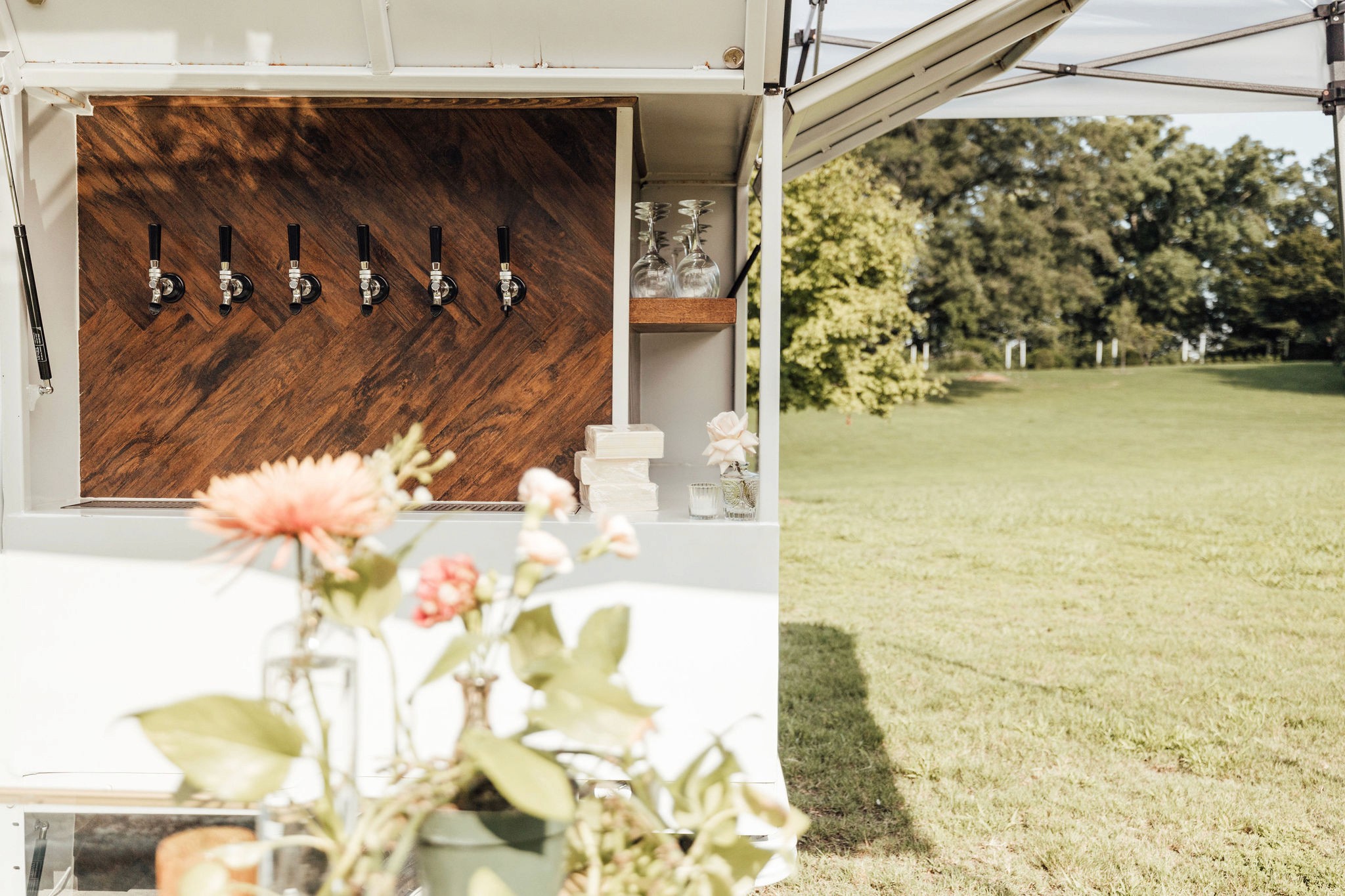 Flower Child Weddings reception styling with coral linens, umbrellas, and garden seating at Berry College.