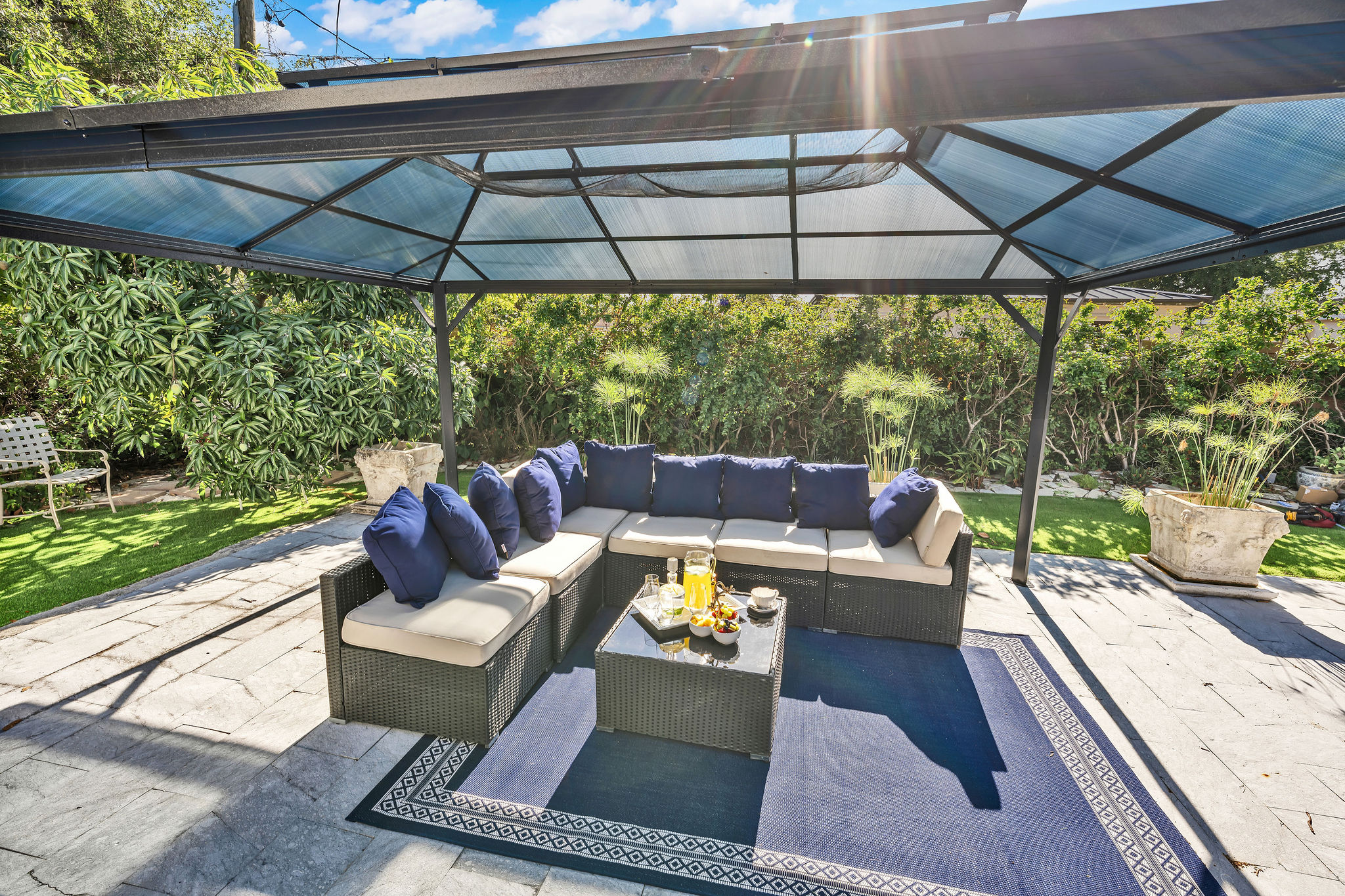 Smiling woman using a rose quartz Gua Sha stone and face roller for a facial massage