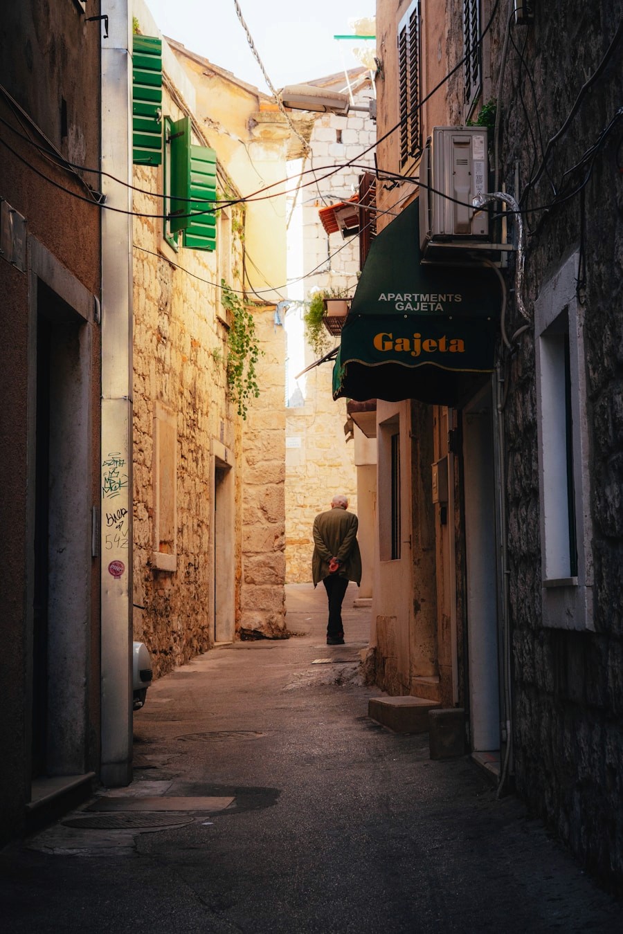 A person walking through a narrow historic alley