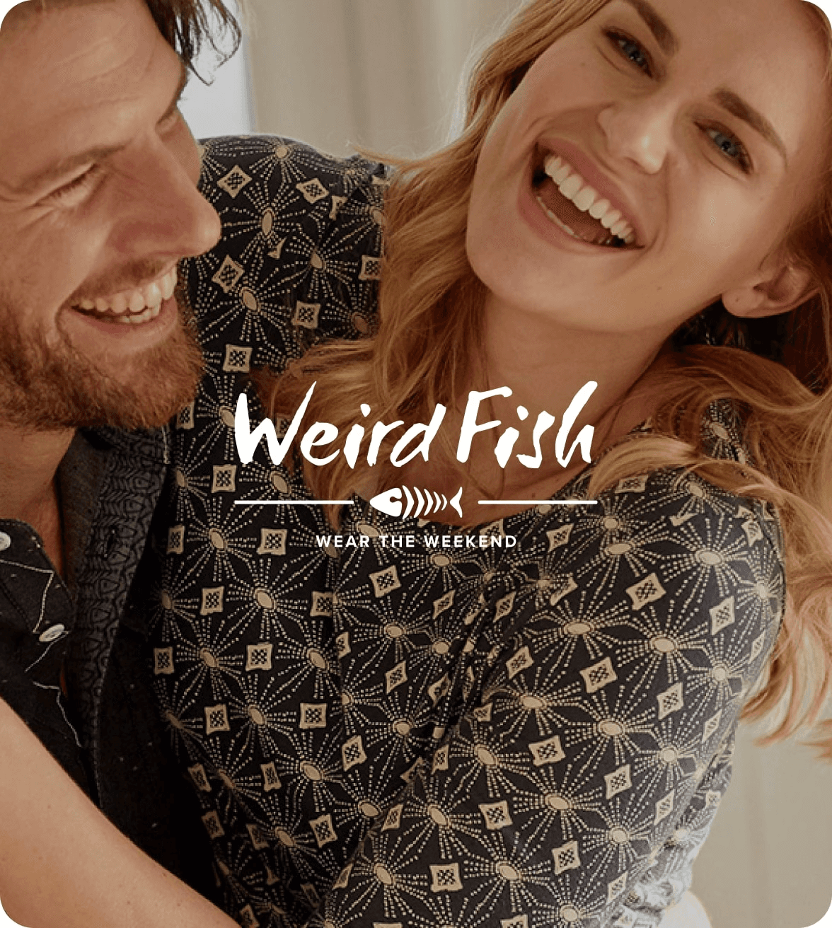 a woman and man hugging and laughing wearing clothing from weird fish with the weird fishlogo overlay