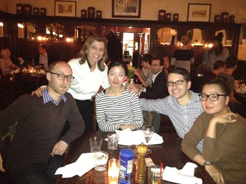 A photo of five people sitting at a table at a restaurant.