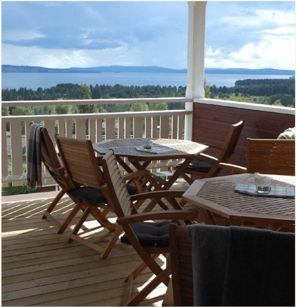 A couple dances closely, showcasing a flowing green dress, against a soft, blurred background of other guests.
