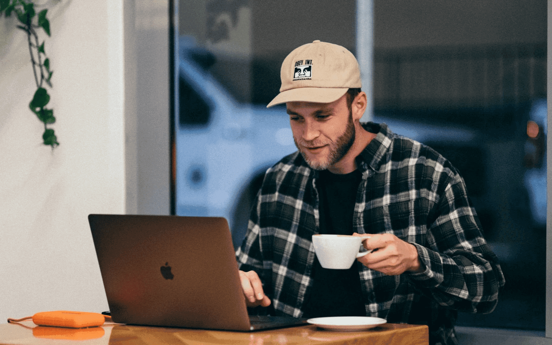 Man working at desk with cup of coffee for recruiters showing modern work culture