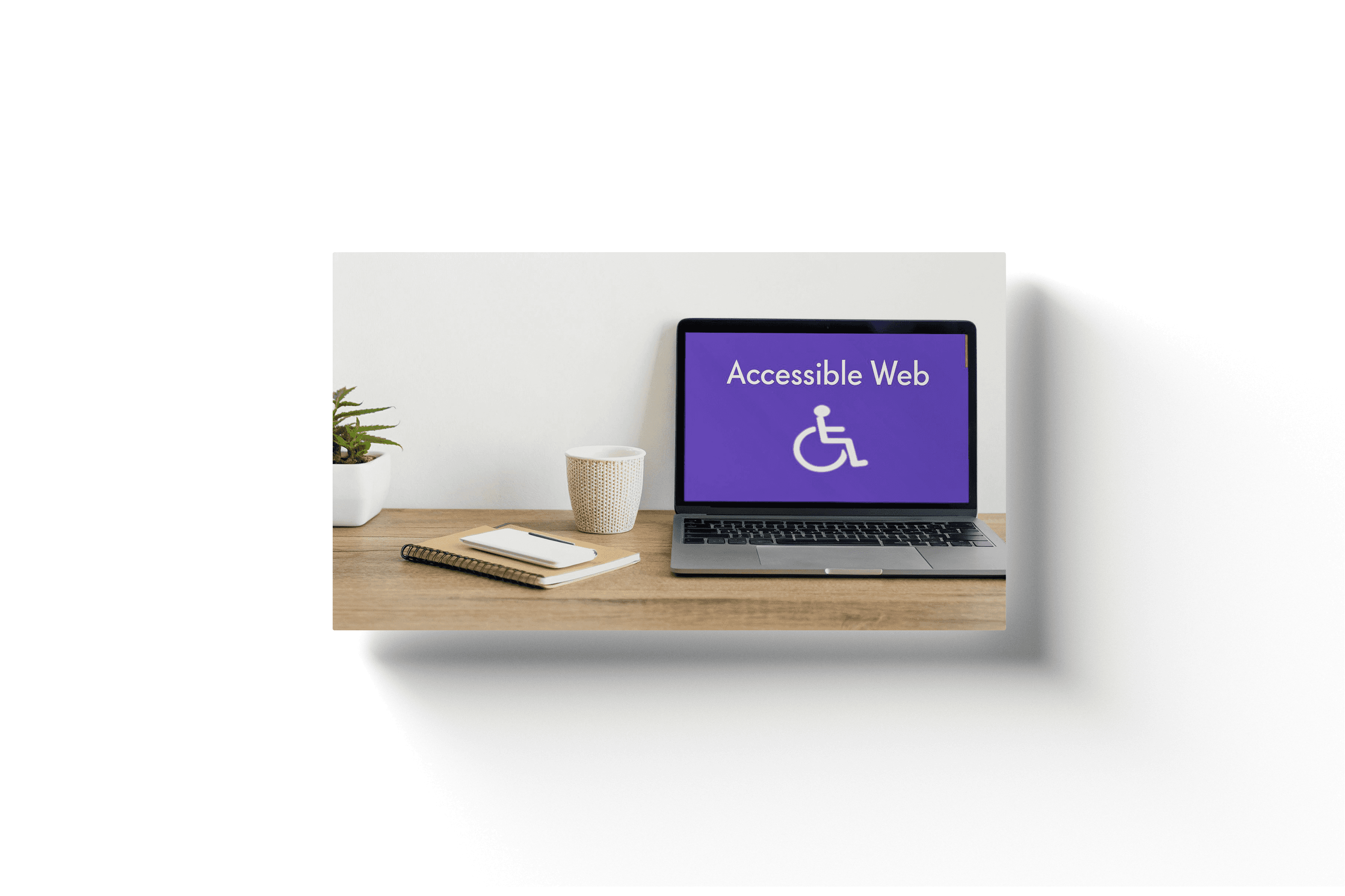a laptop on wooden desk depicting an accessibility icon with the text 'accessible web' overhead