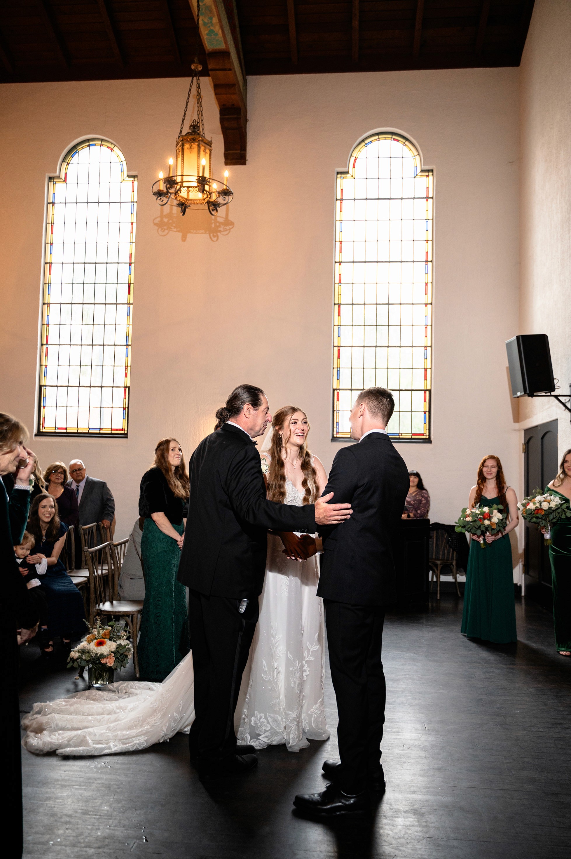 Flat lay wedding details with bouquet, rings, and sparkling bridal heels