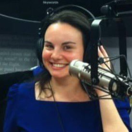 a close up of a white tiger near a building