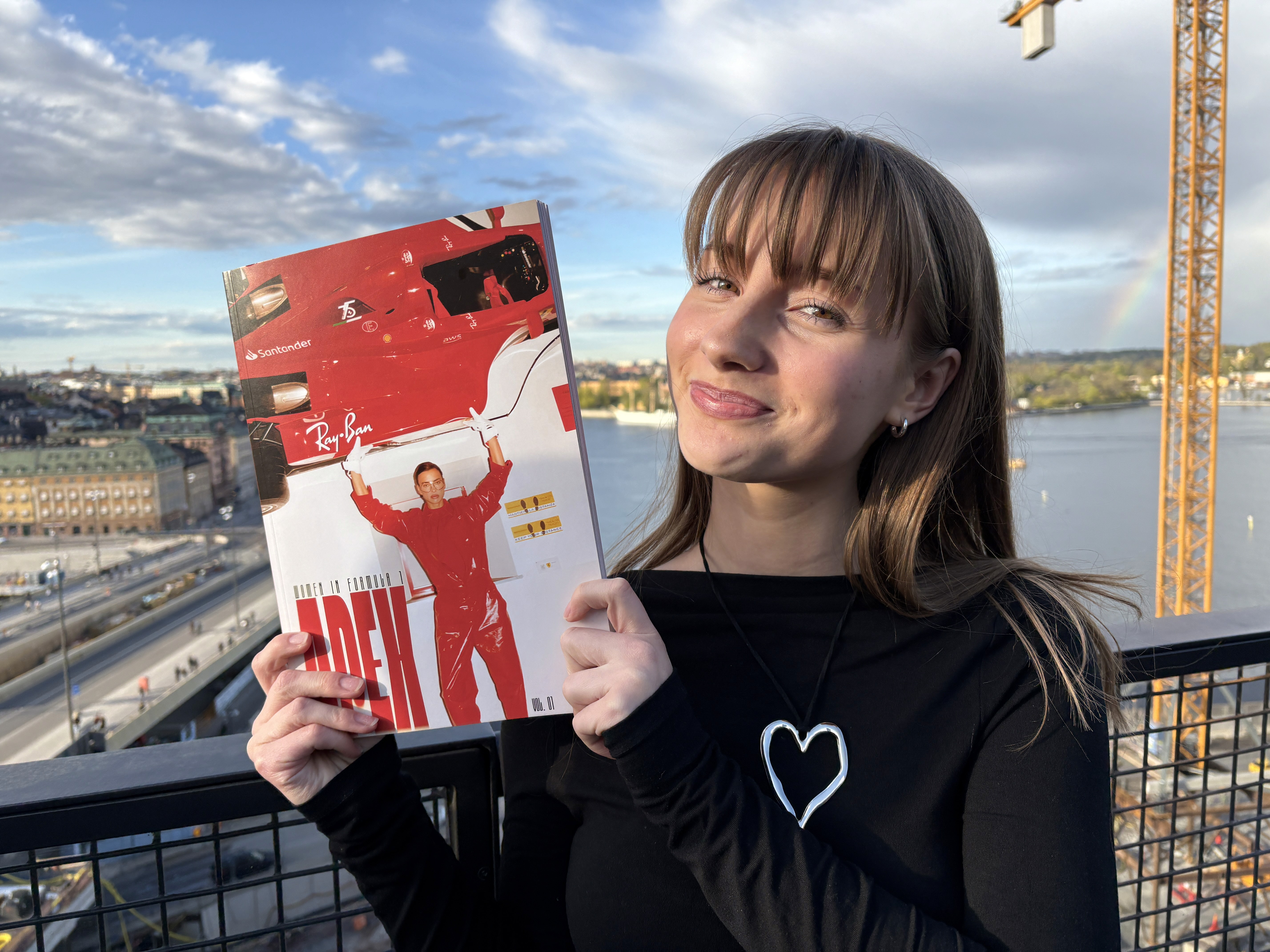 A thoughtful young person with dark hair gazes to the side, captured in soft black and white lighting.