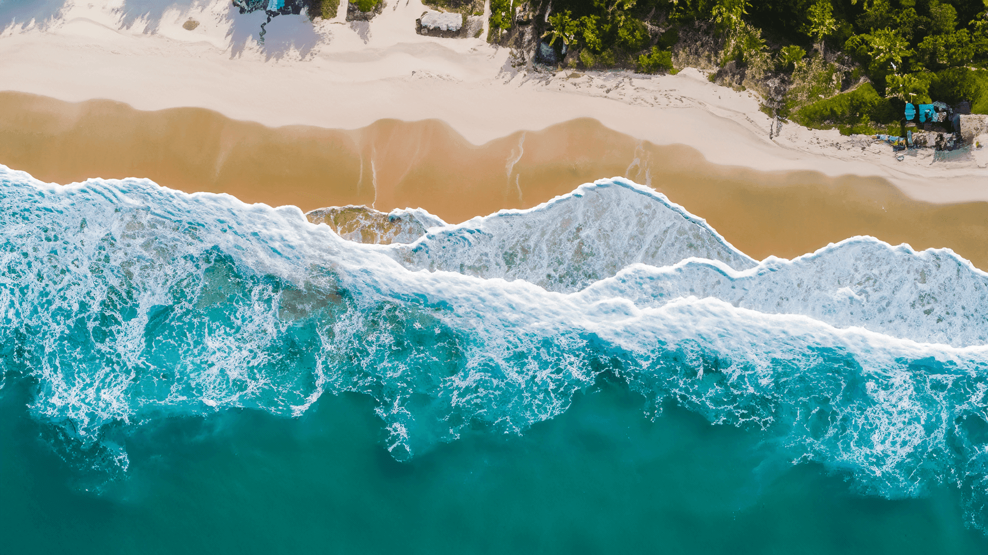 Panoramic view of the golden sands and turquoise waters of Vieques beach, setting the perfect backdrop for your stay at Club Vieques.