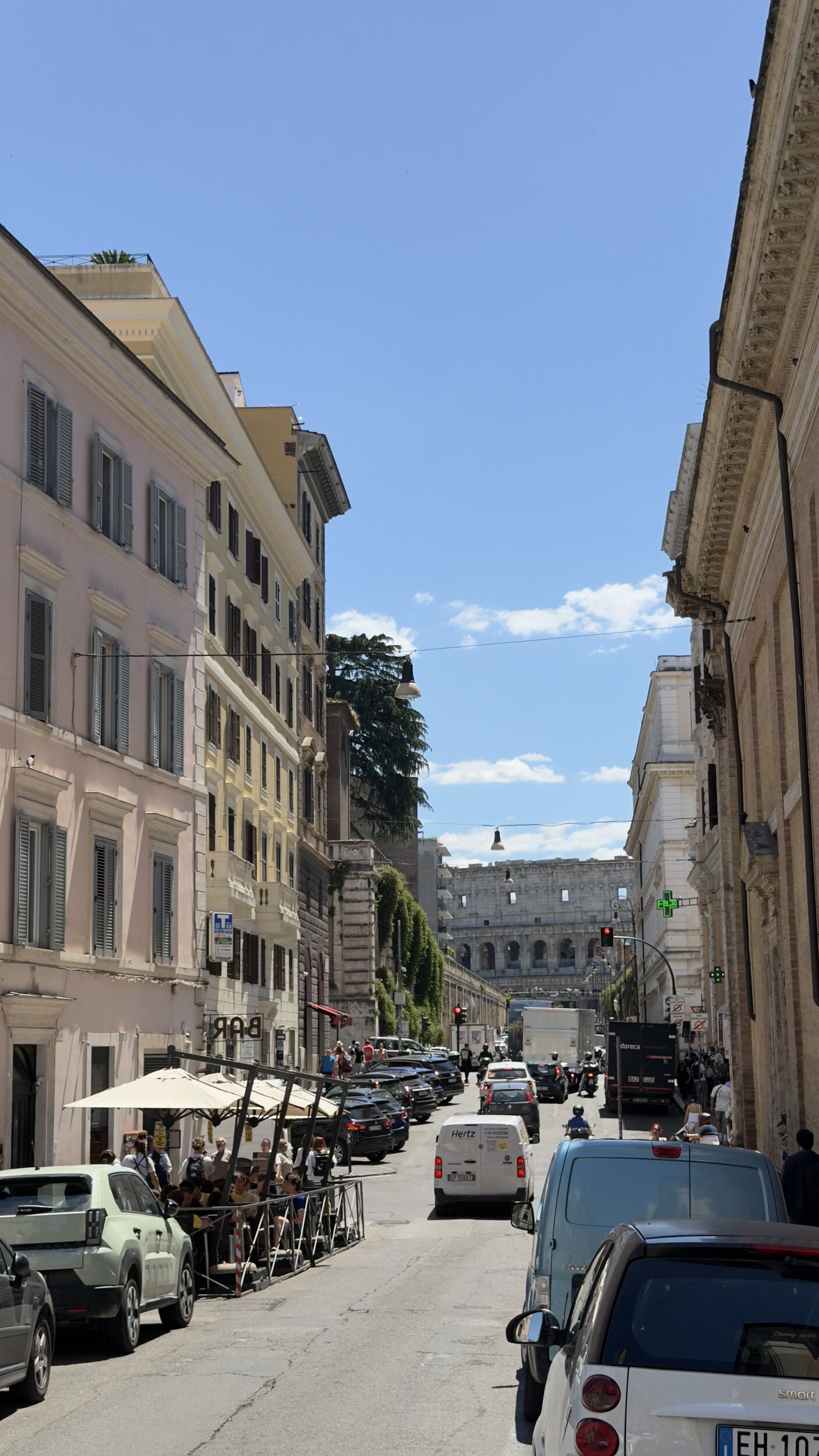 Pastel facades and artisan shops along Via dei Serpenti, the spine of Rione Monti, Rome