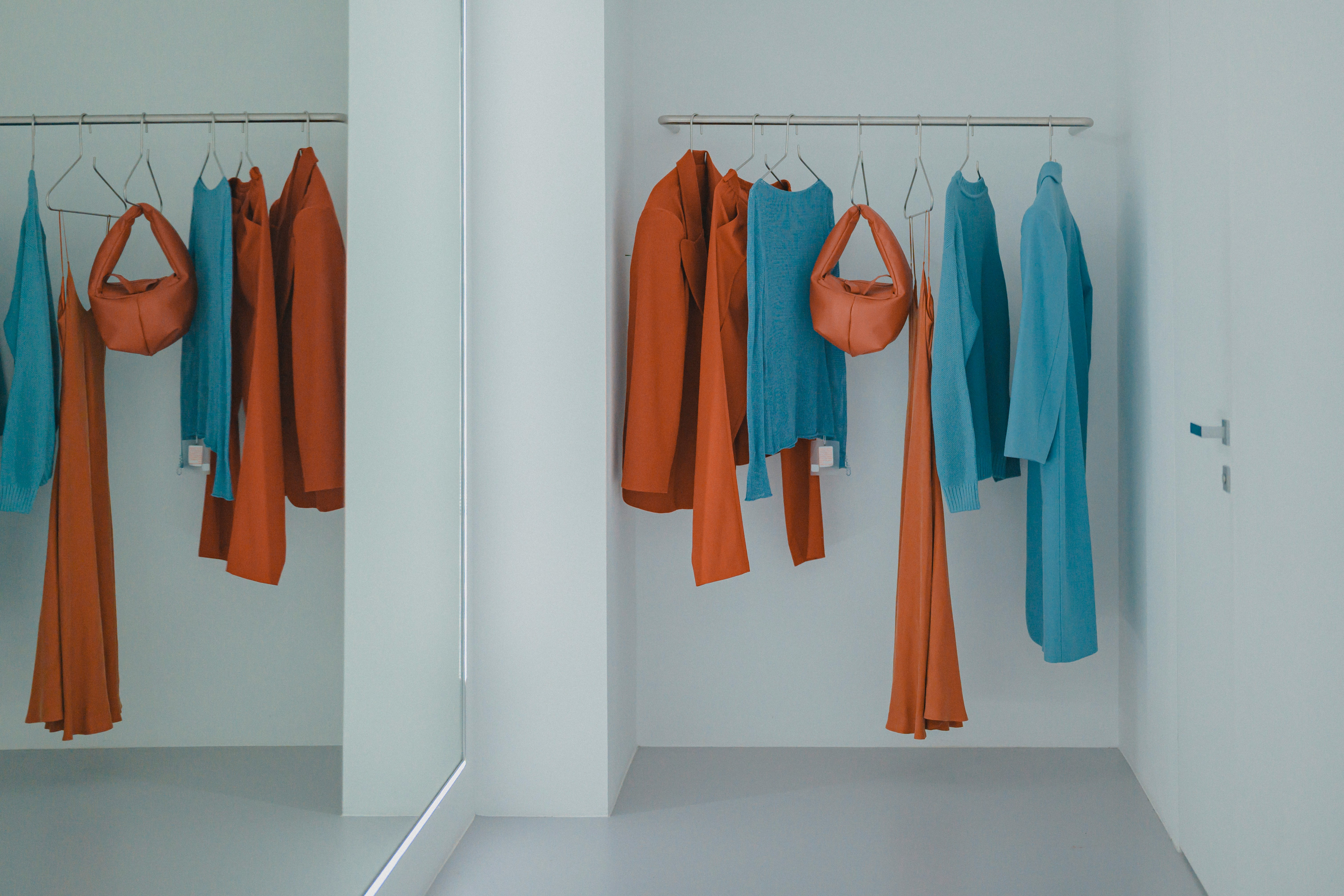 A room that has a bunch of clothes hanging on a rack
