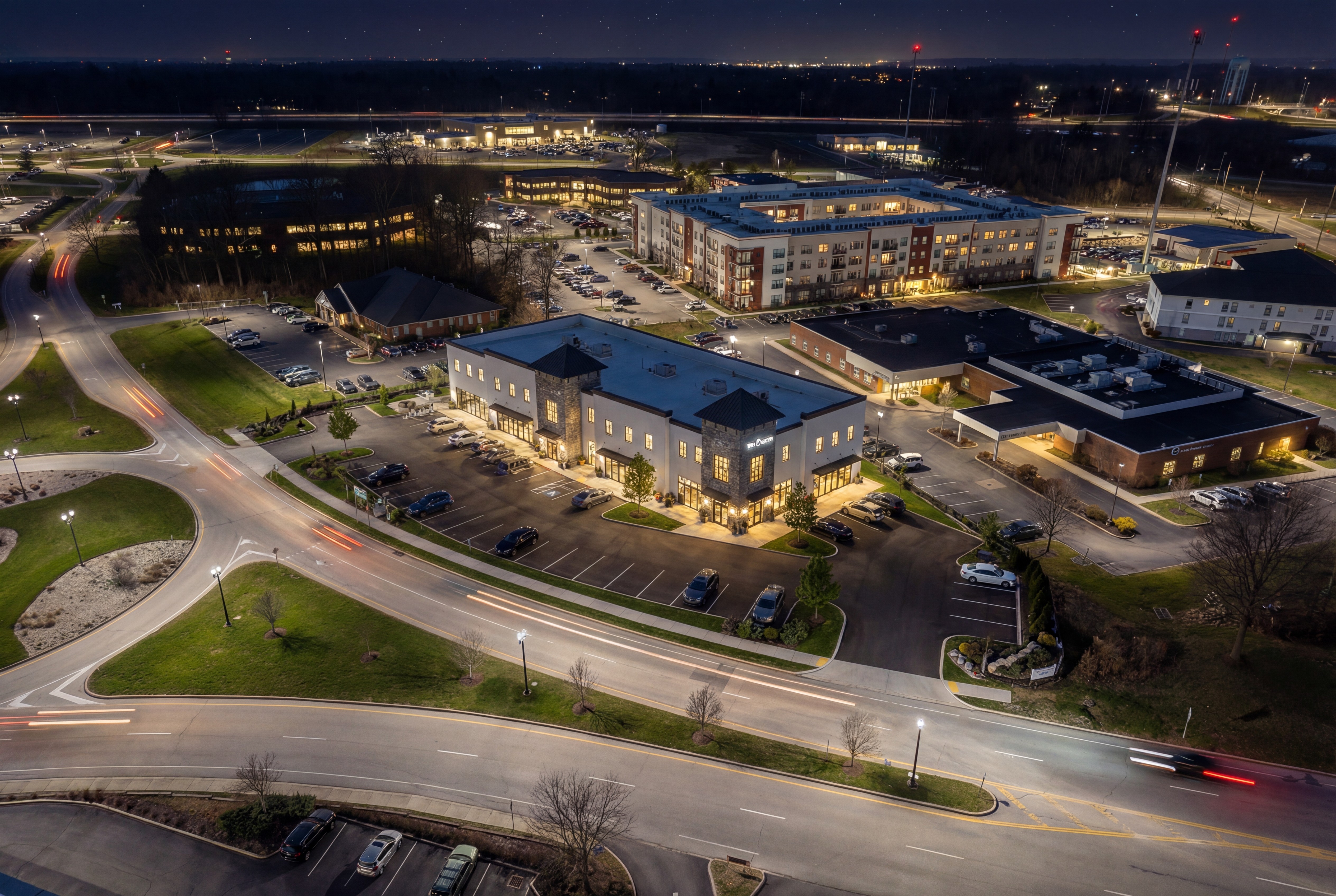 Modern kitchen and dining area with wood cabinets and large windows