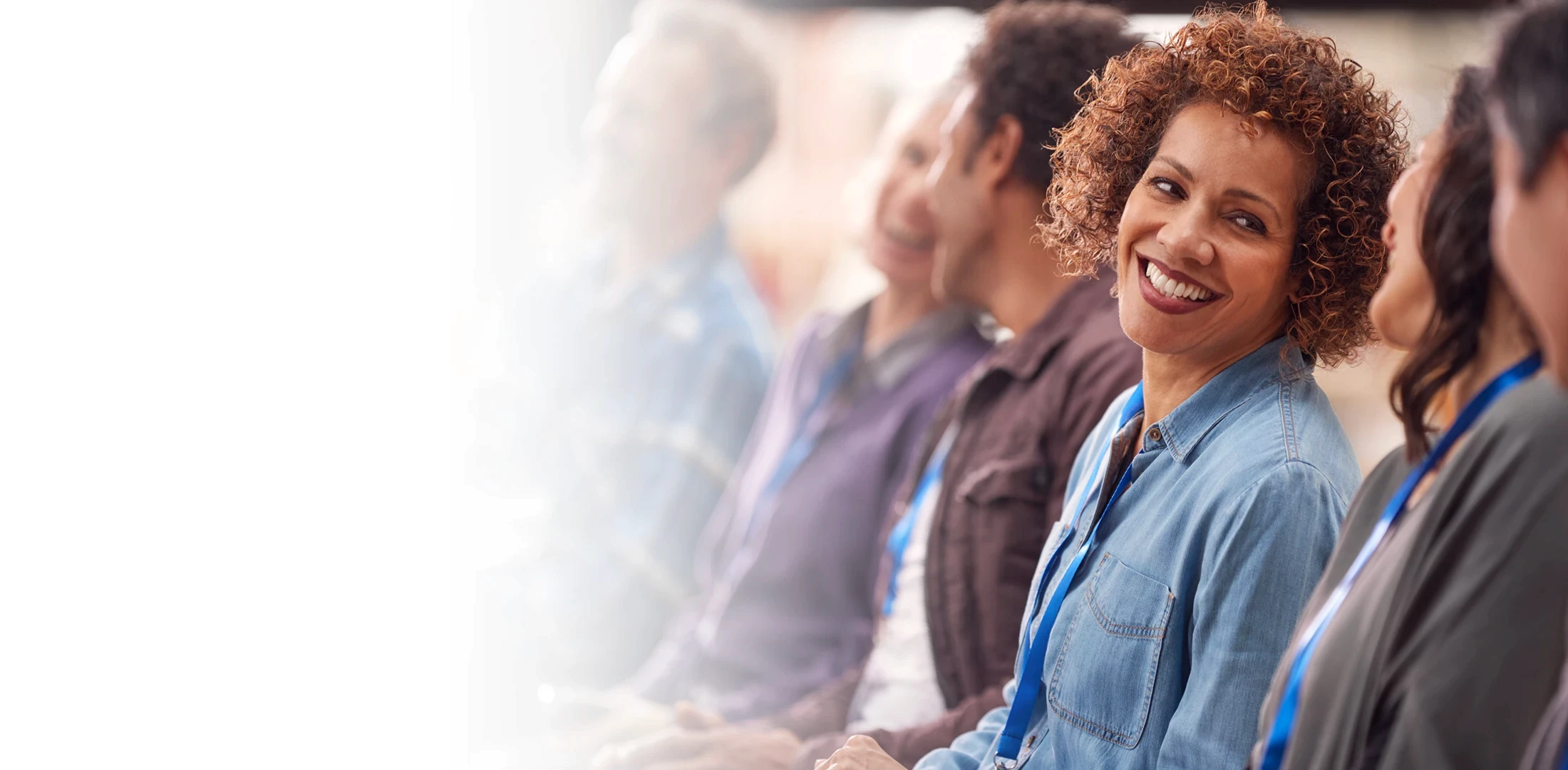 Photo of woman and child lying down, smiling at each other.