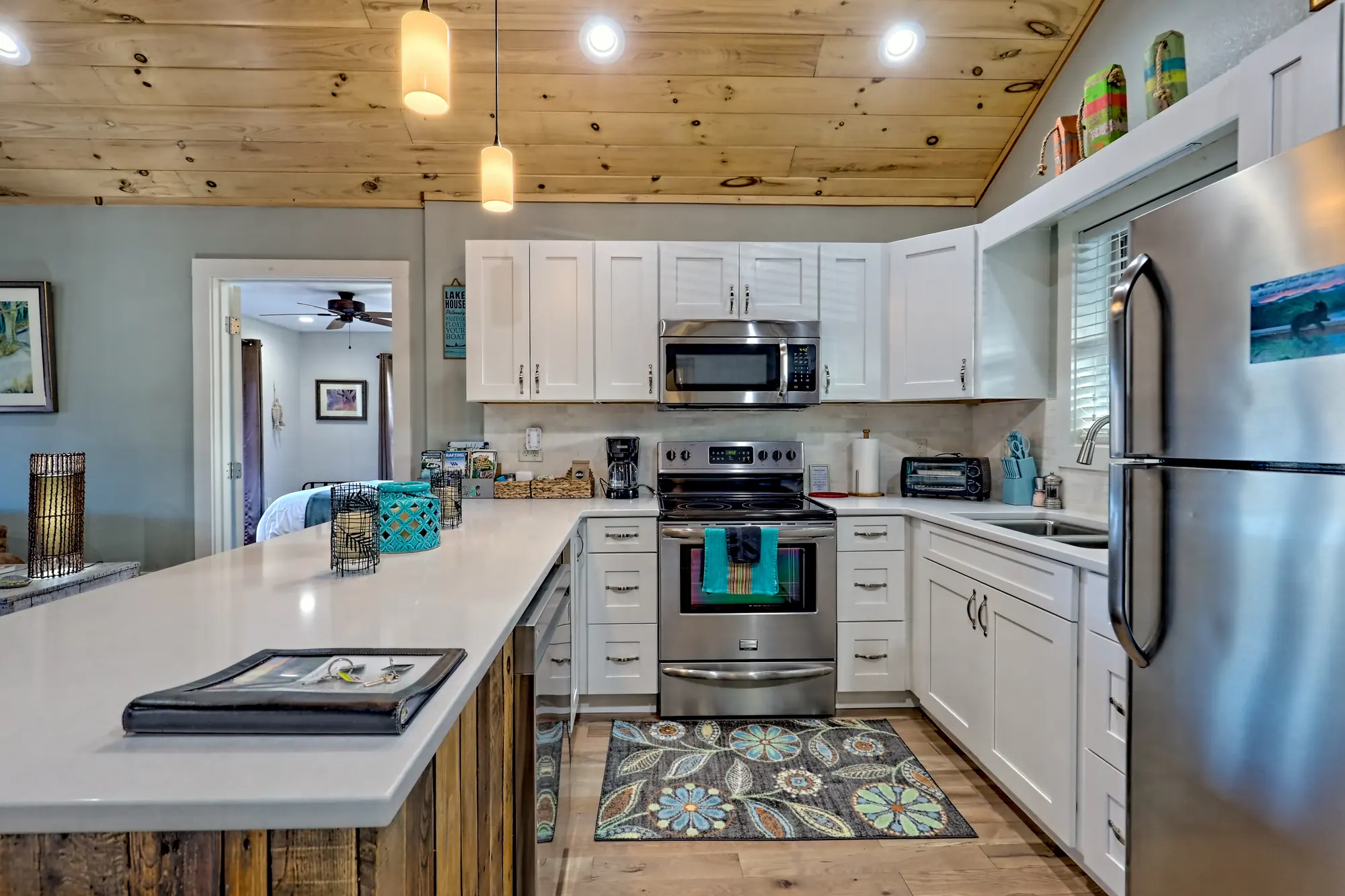 Eagles Nest kitchen with white cabinets, quartz island and stainless appliances