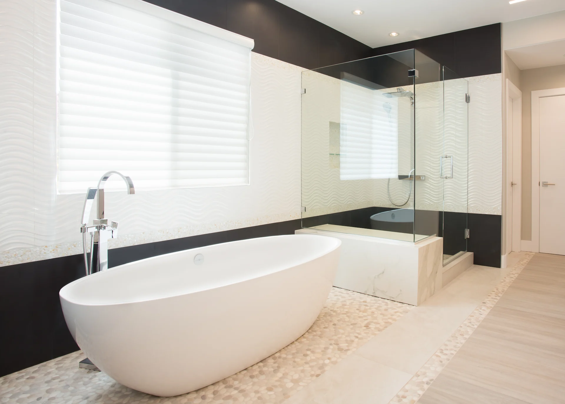 View from angle 2 of the master bath, featuring the free-standing tub and shower, a blend of modern luxury and comfort in the Harbor Cove remodel.
