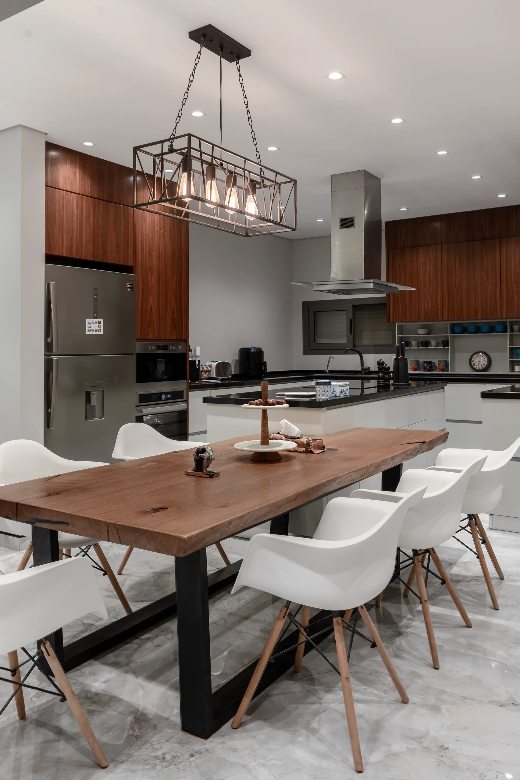 Vertical view of the Caesar SODIC Villa dining table and open kitchen.