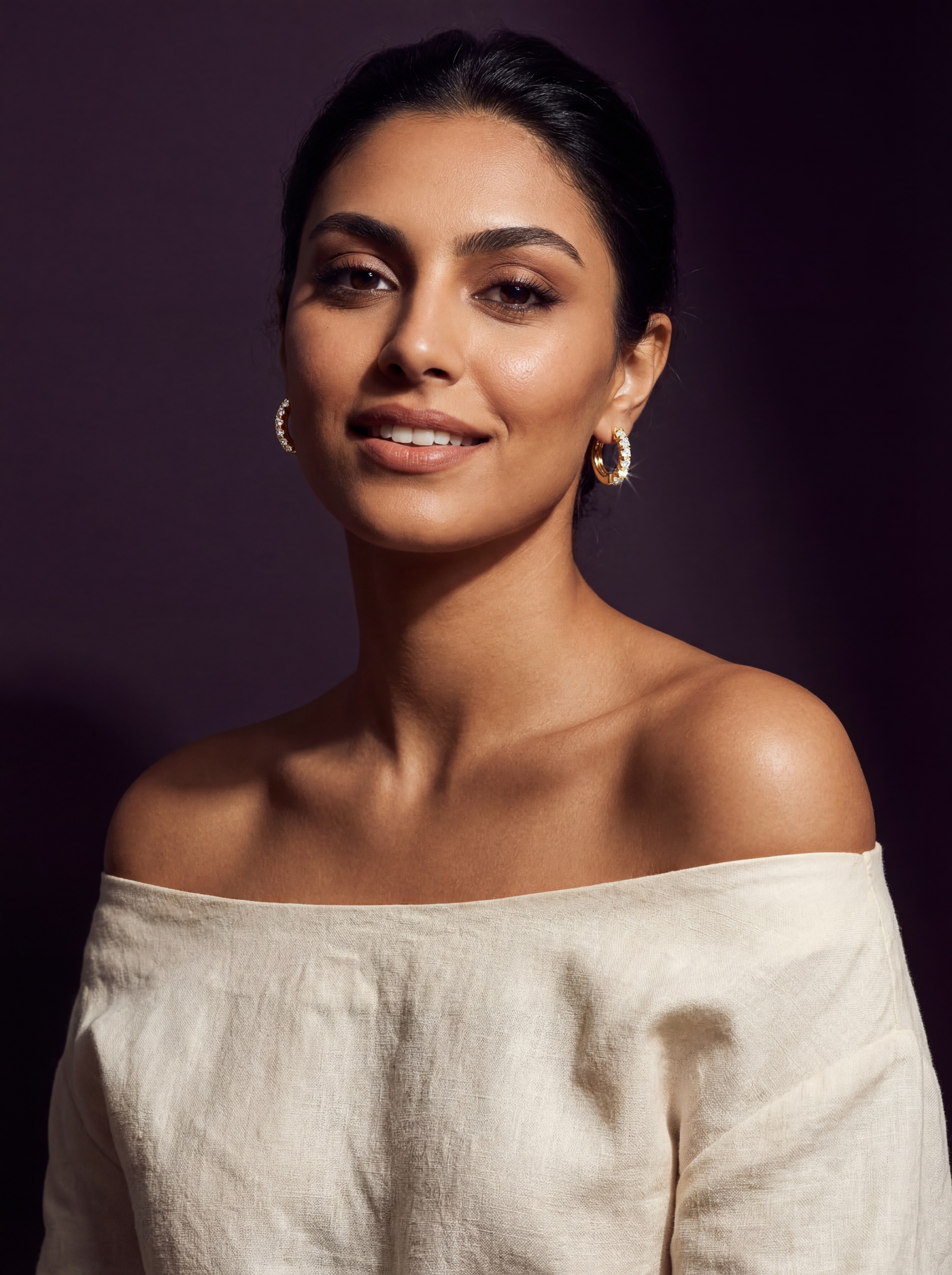 Layla Al-Masri AI model wearing gold hoop earring, deep purple editorial background, off-shoulder elegant styling, Gemzy AI jewelry studio