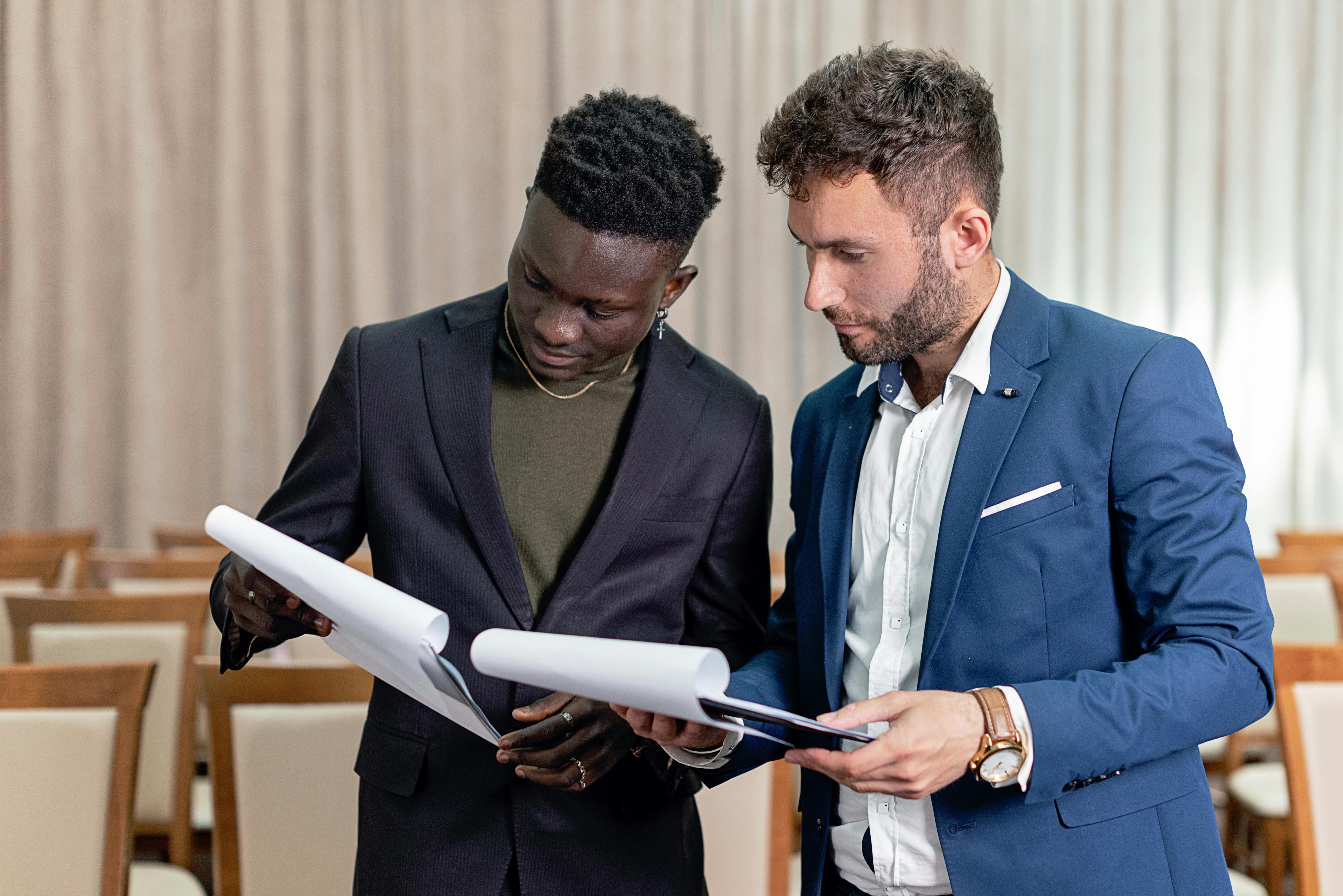 Two professionals discussing contract details, highlighting Roger's new features for faster contract creation and easier signing.