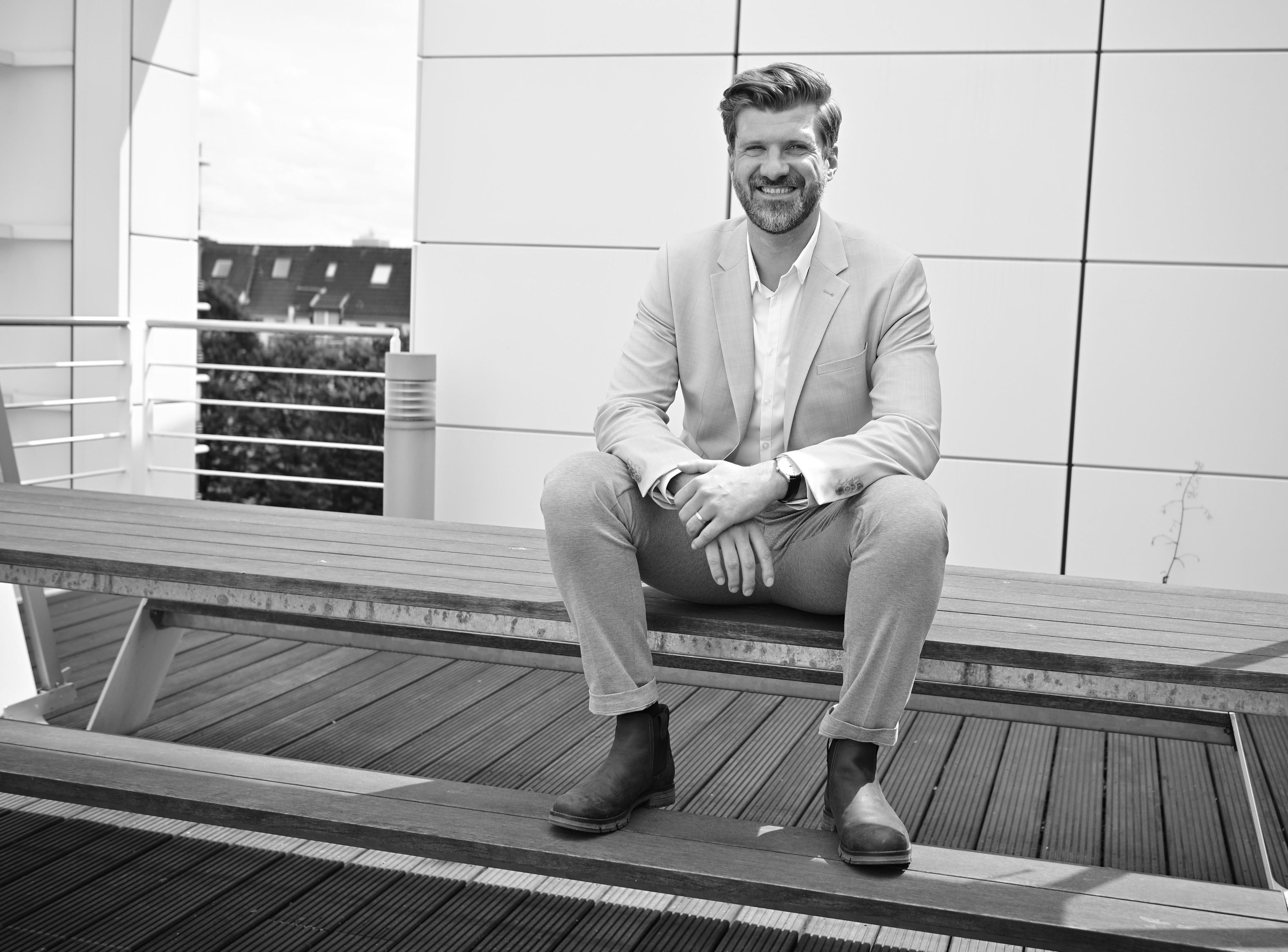 Mann sitzt auf einem Tisch