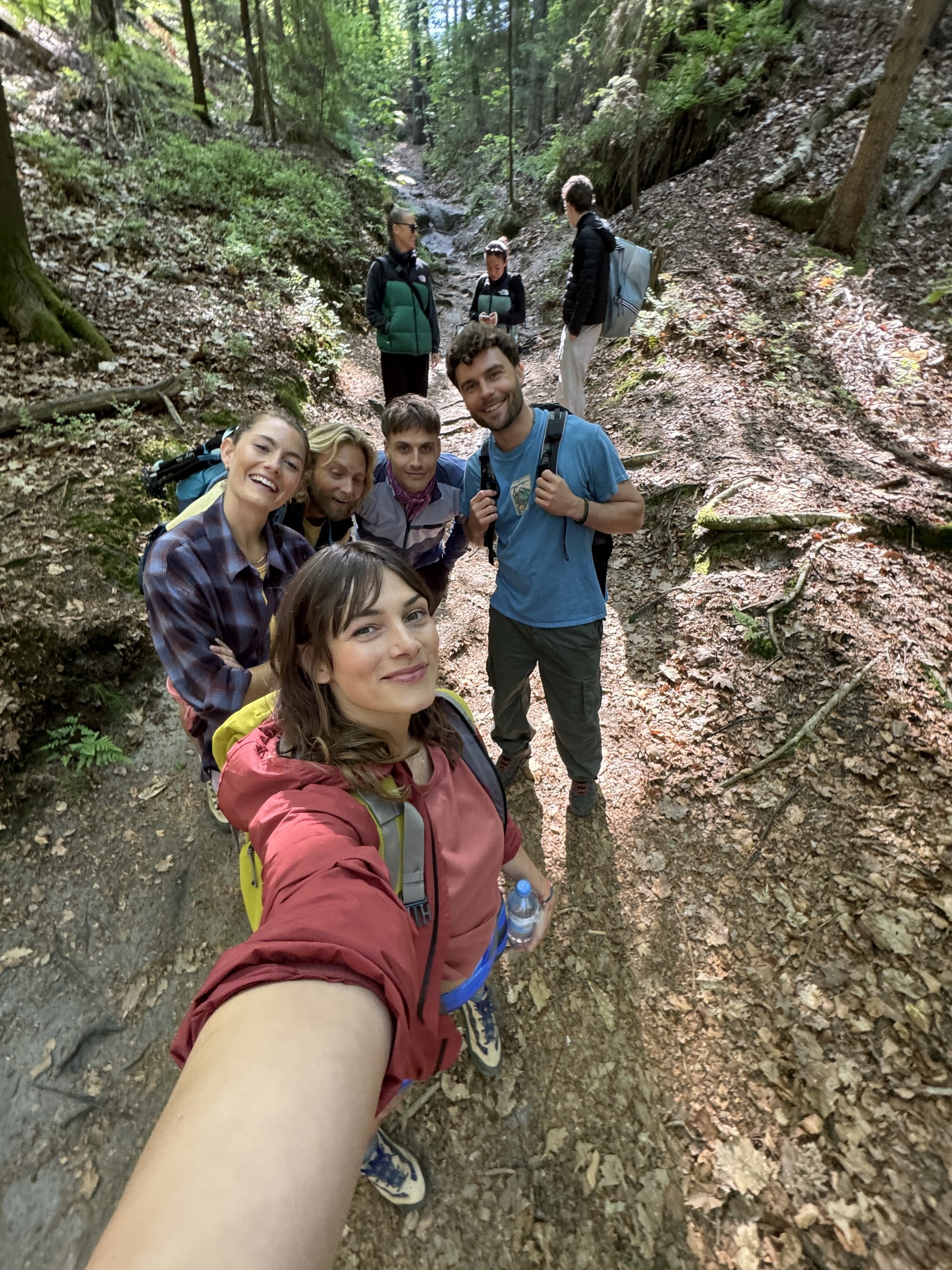 The Radeberger commercial cast hiking up a forest trail in the Elbe Sandstone Mountains