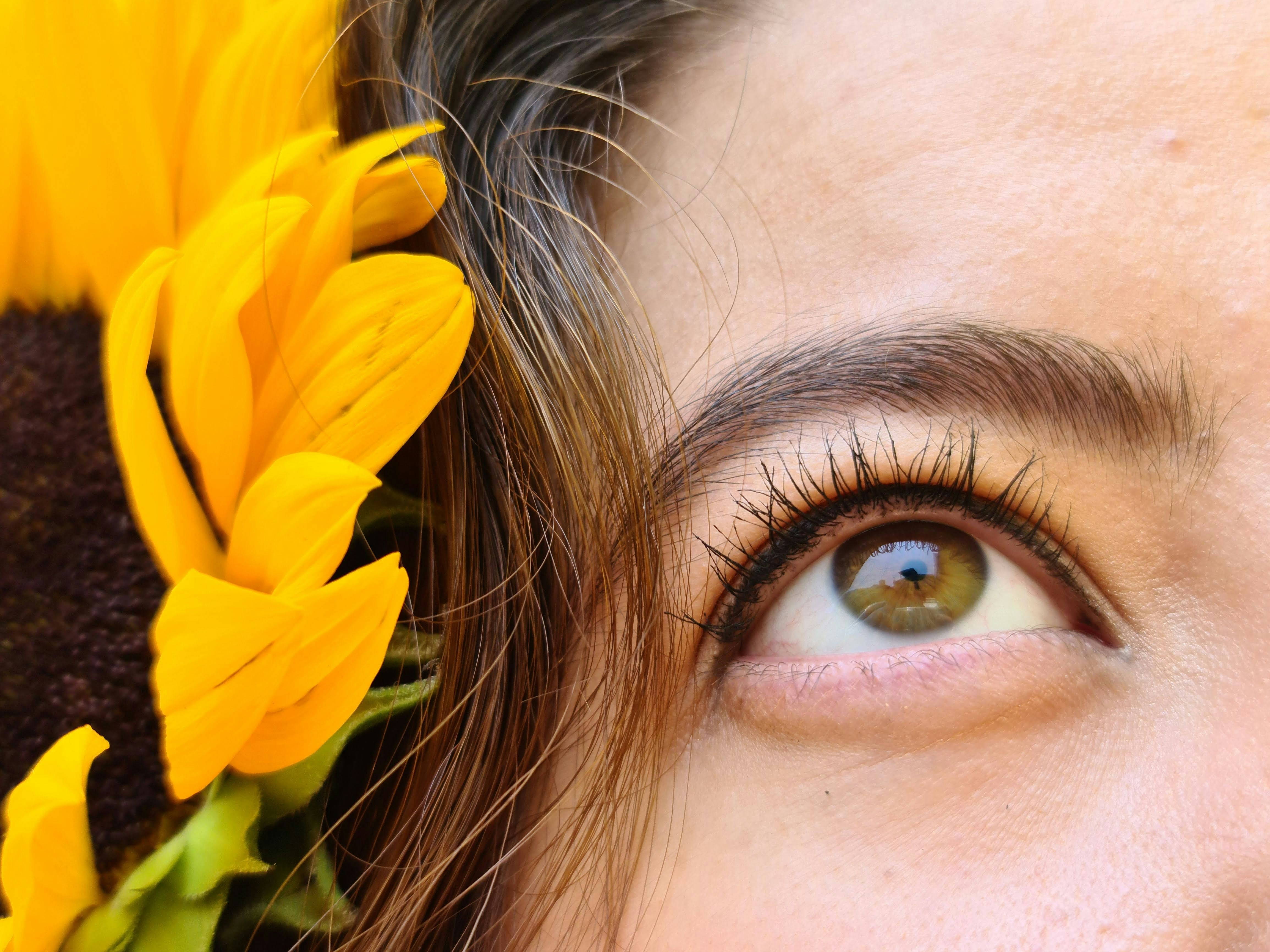 a close up of a person with a sunflower