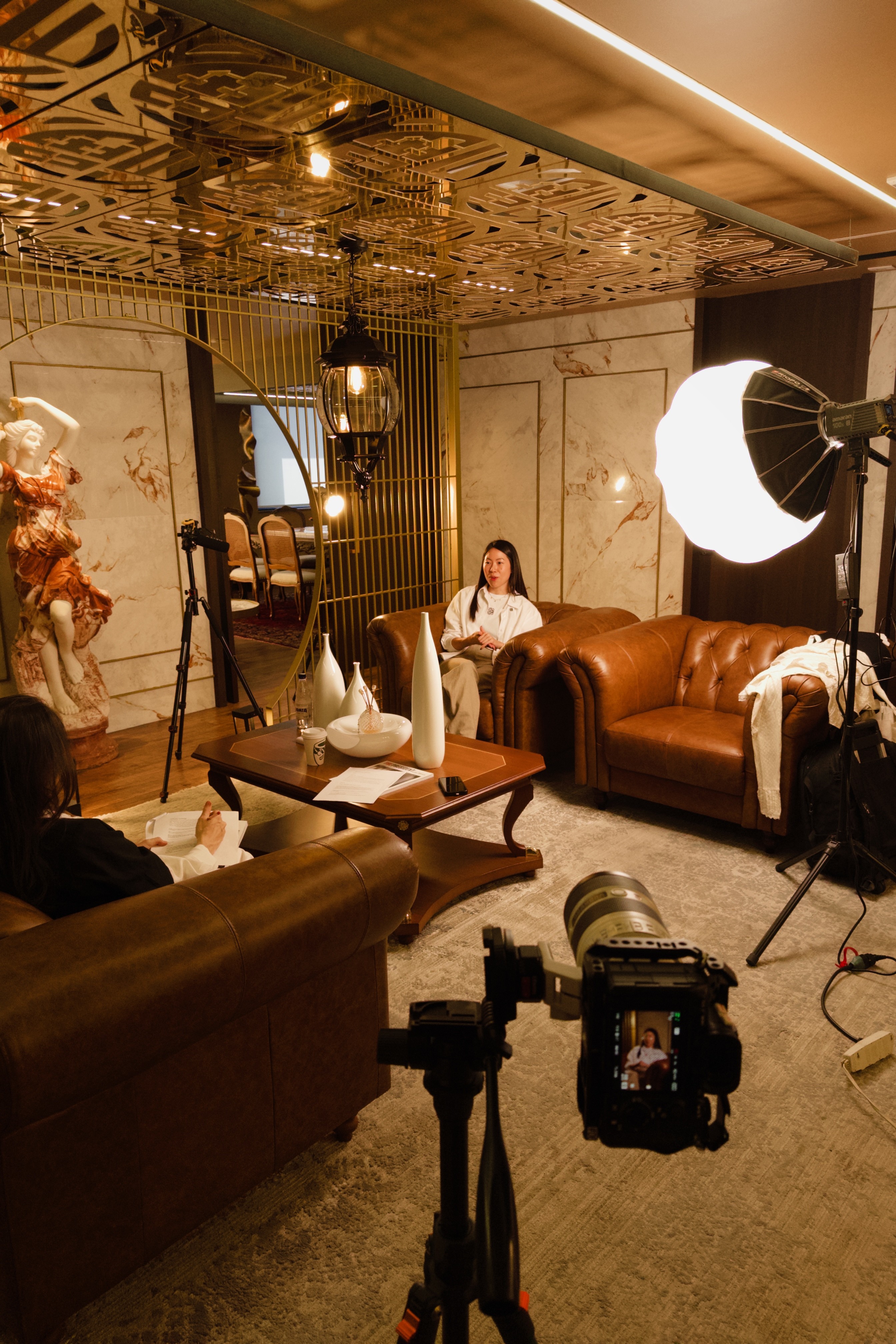 Close-up of a dark green leaf showing its textured surface and central vein against a muted background.