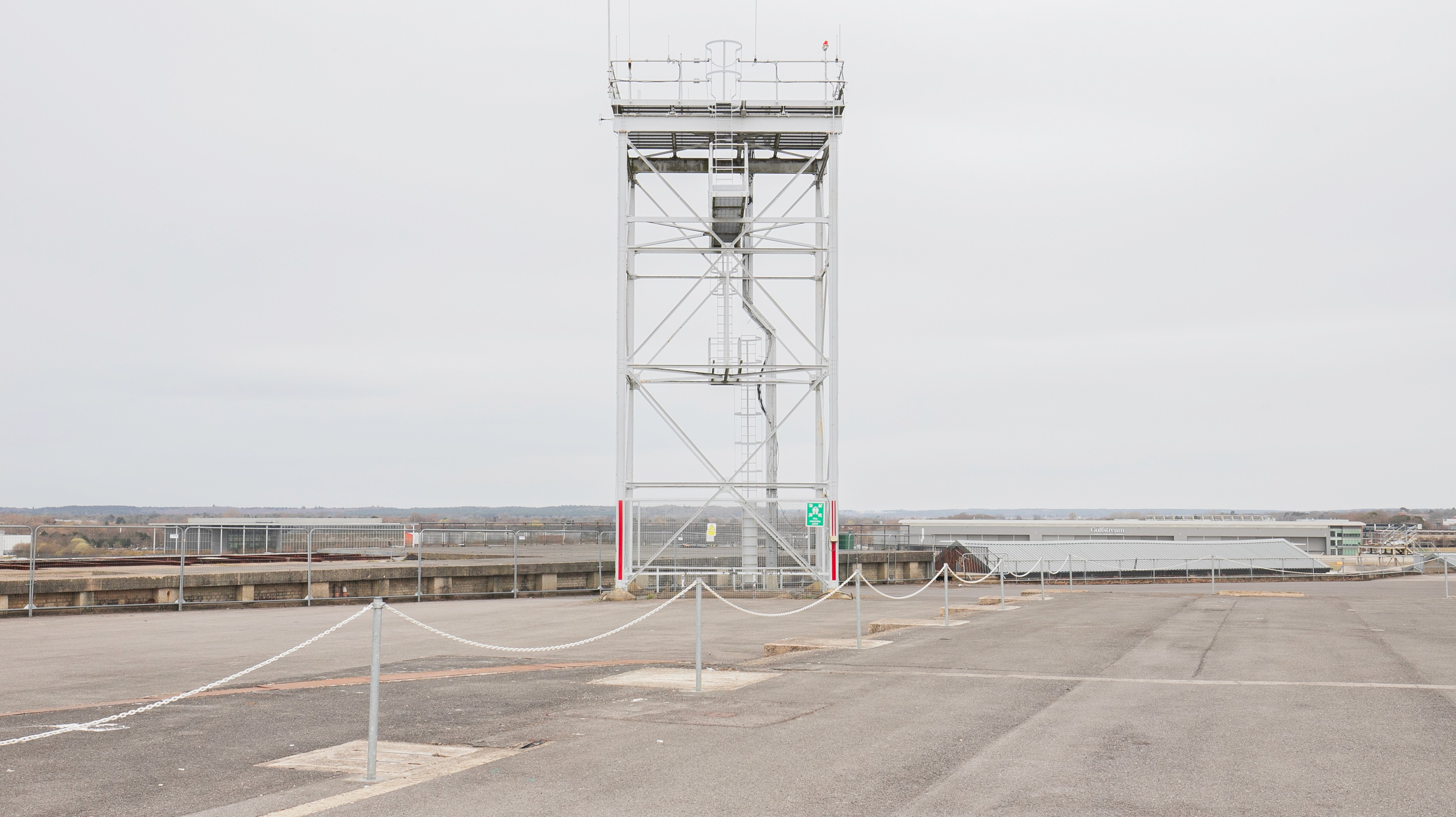 Two classic volkswagen beetles, one green, one cream.