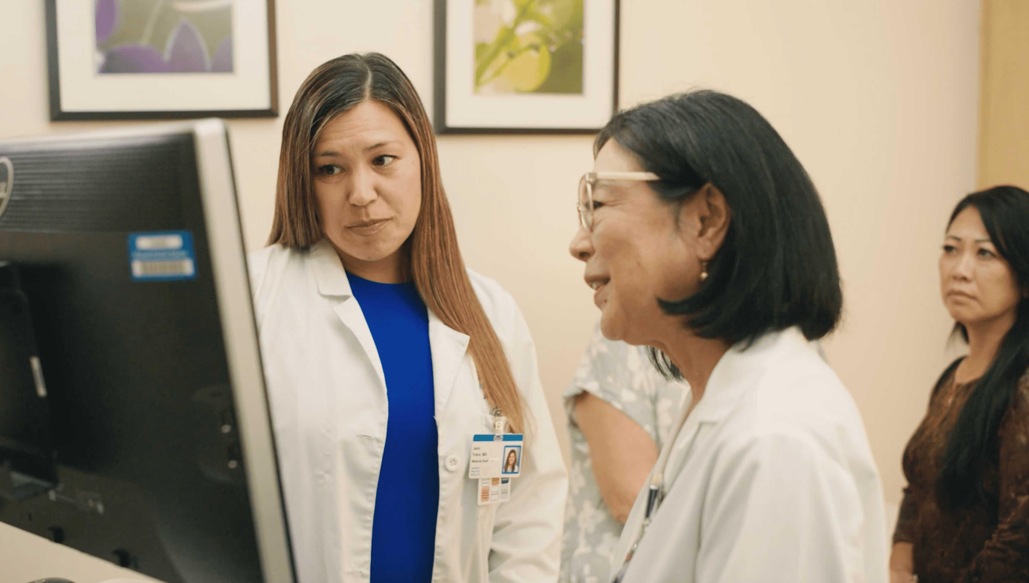 Doctors speaking with patient in clinical setting