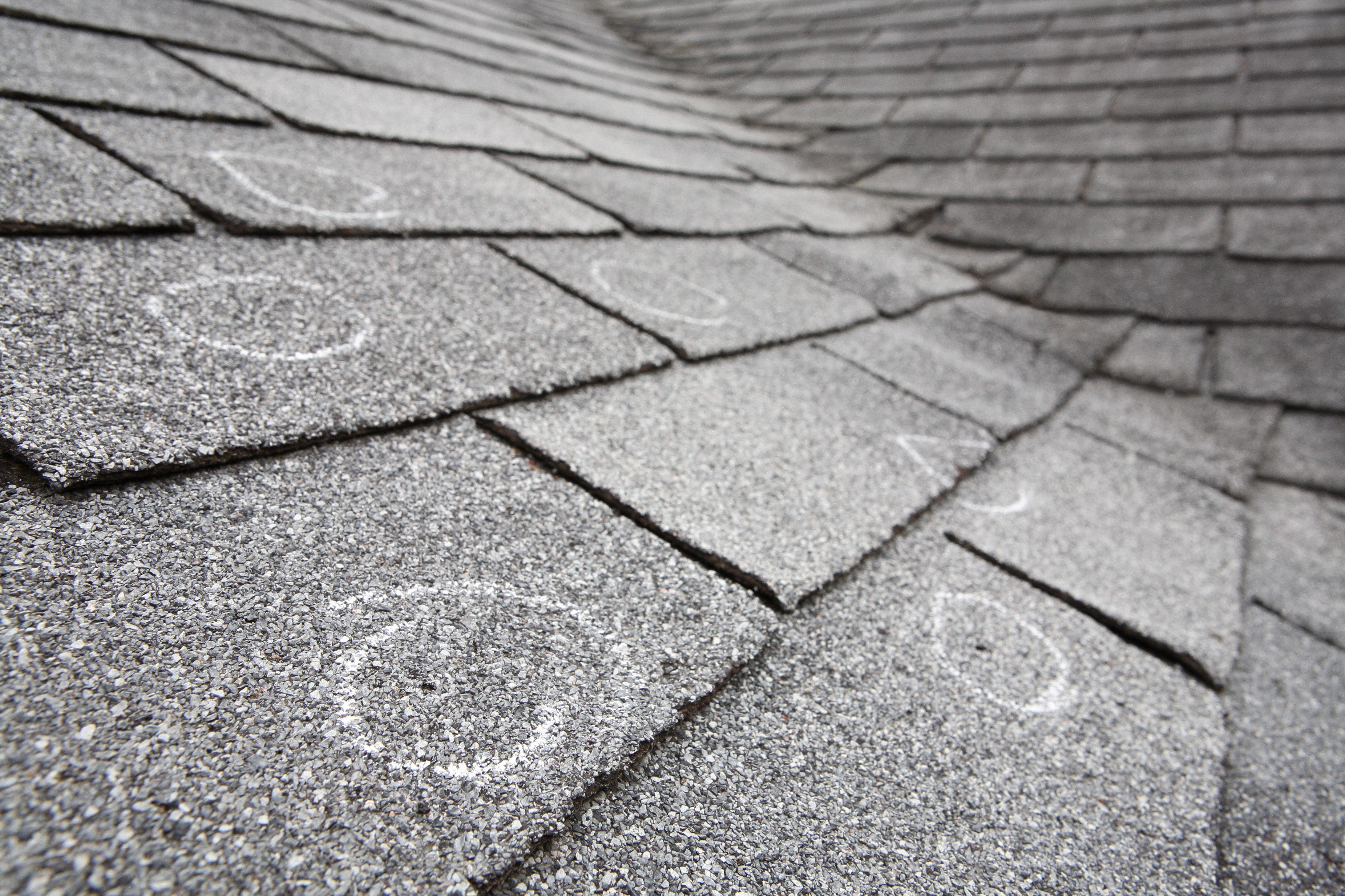 St. Louis roof with severe wear and storm damage before repair