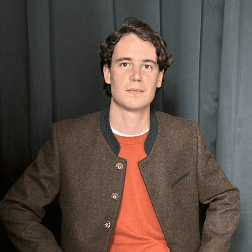 a man in a suit posing for a picture