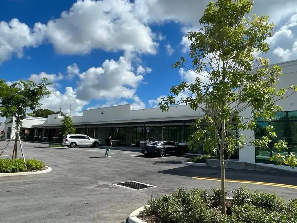 SPSA Retail Center rear parking lot with landscaped islands and storefront windows