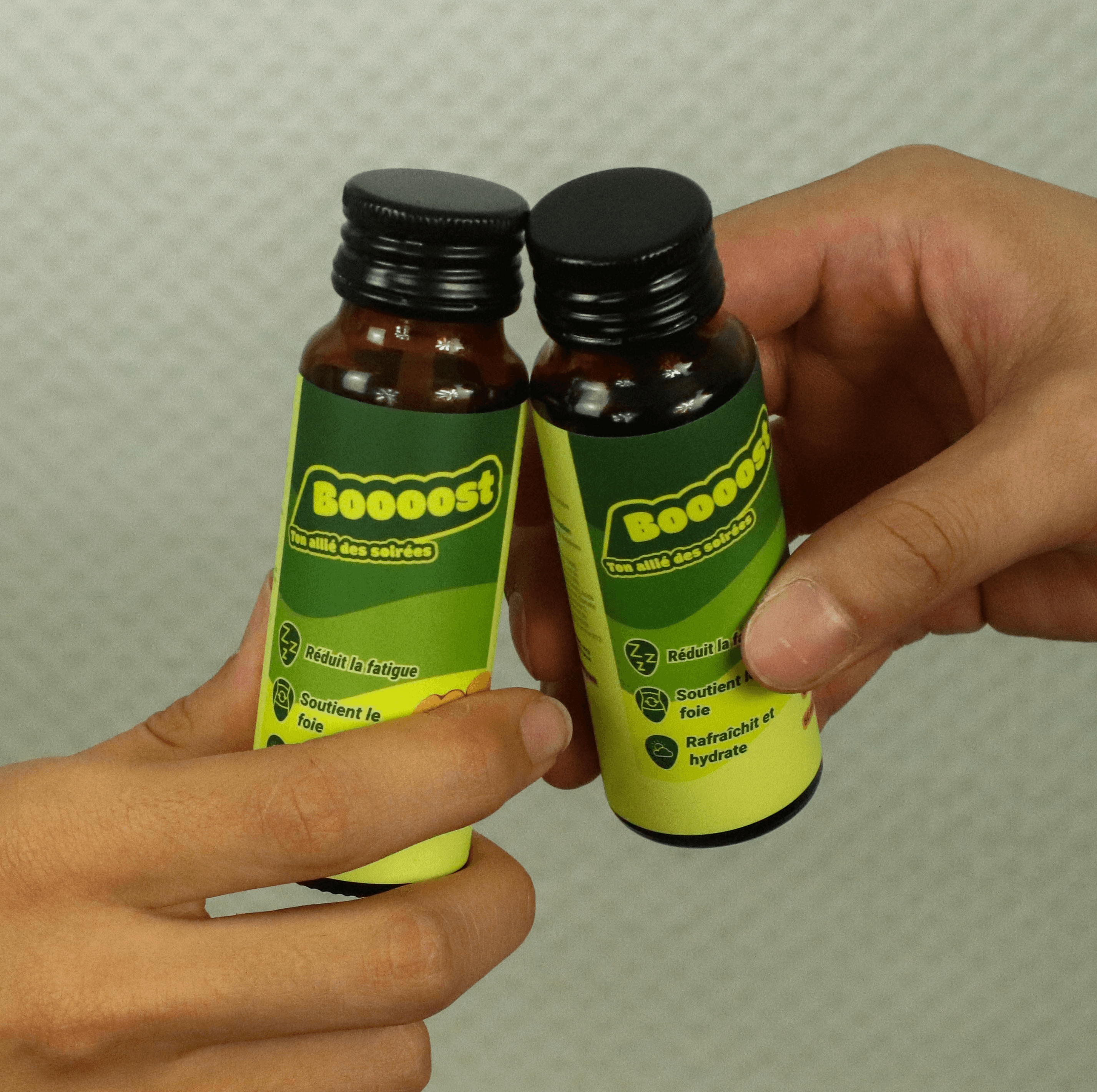 A smiling young man with crossed arms, wearing a plaid shirt and white t-shirt, poses against a dark background.