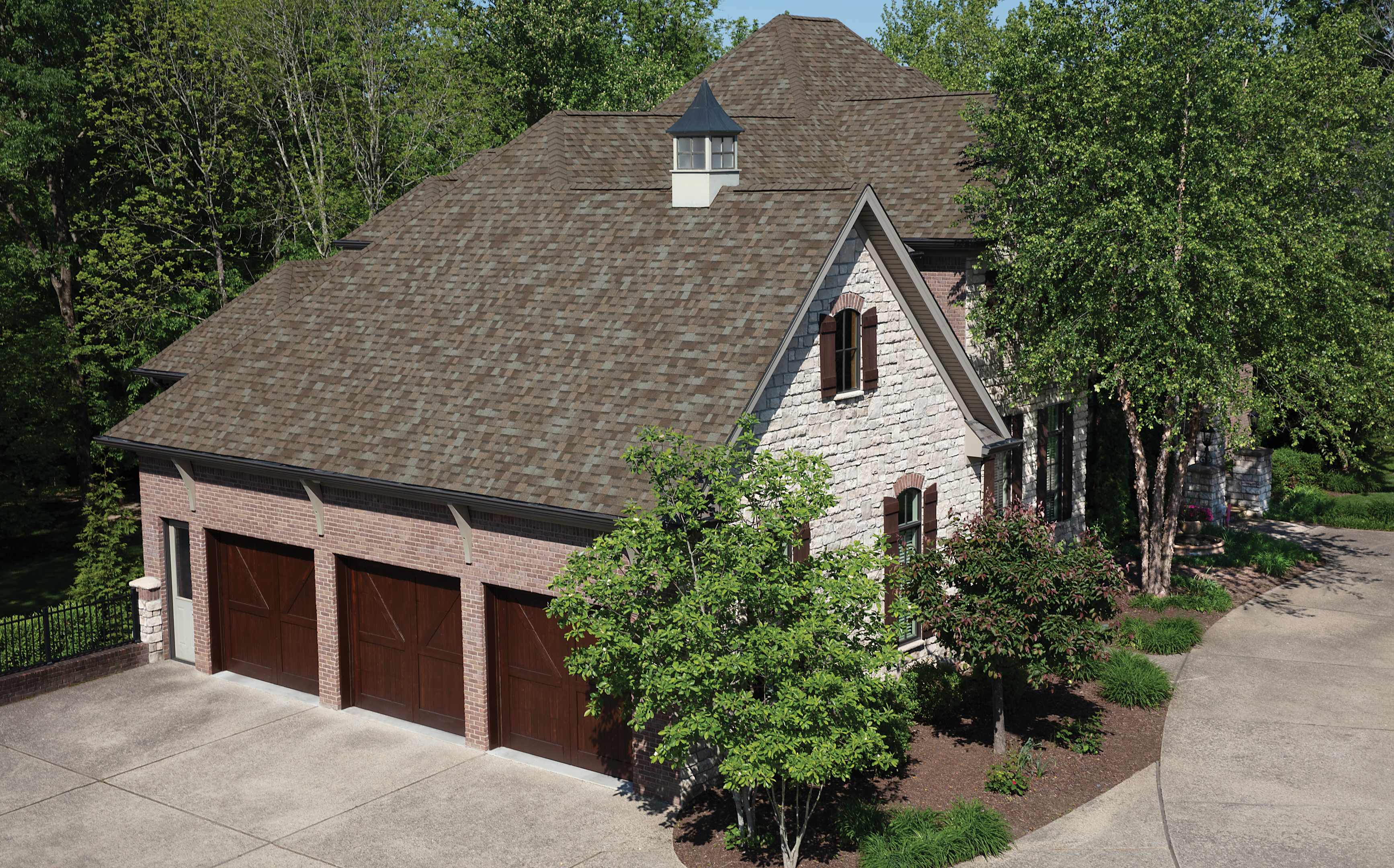 Beauty shot of a beautiful home with Owens Corning TruDefinition Duration shingles in Driftwood color.