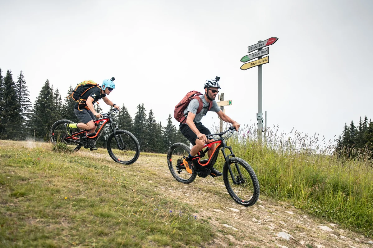2 cyclists with alpin, wearing hat & GoPro.