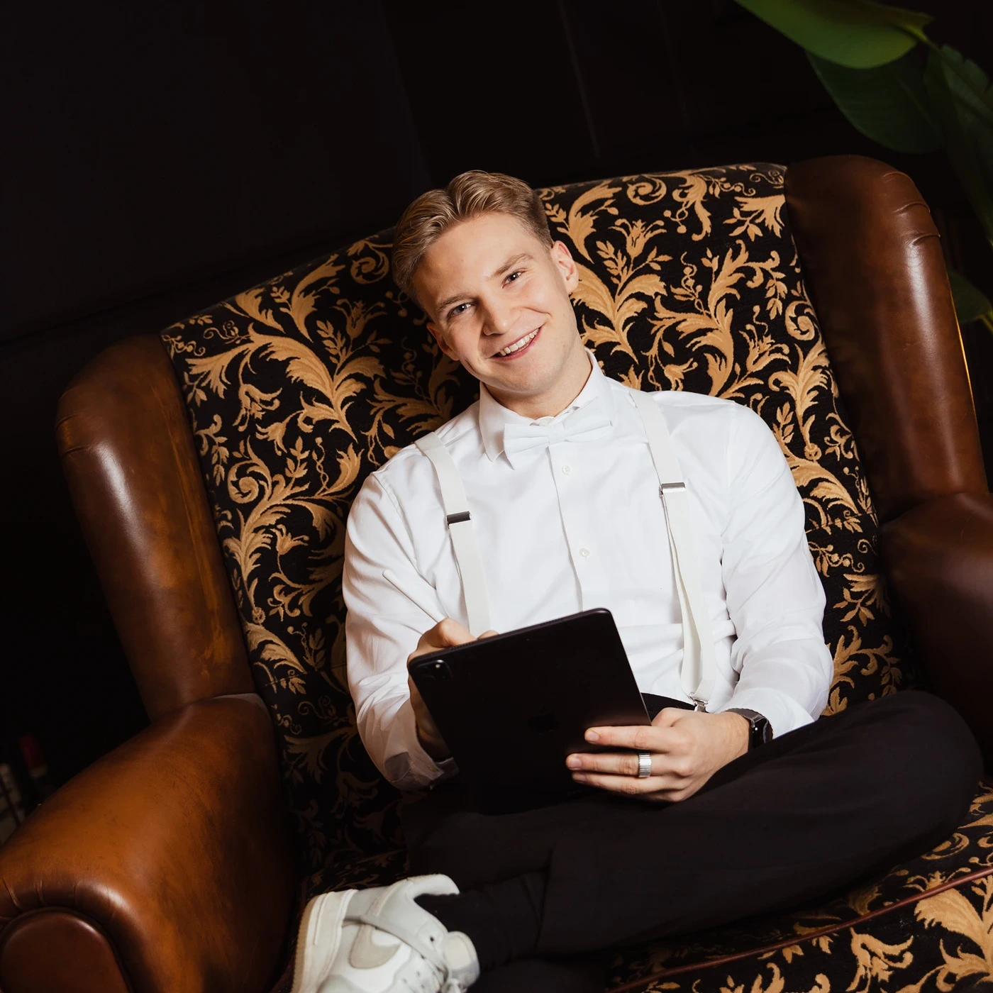 A red hot air balloon glows at sunset over mountains.