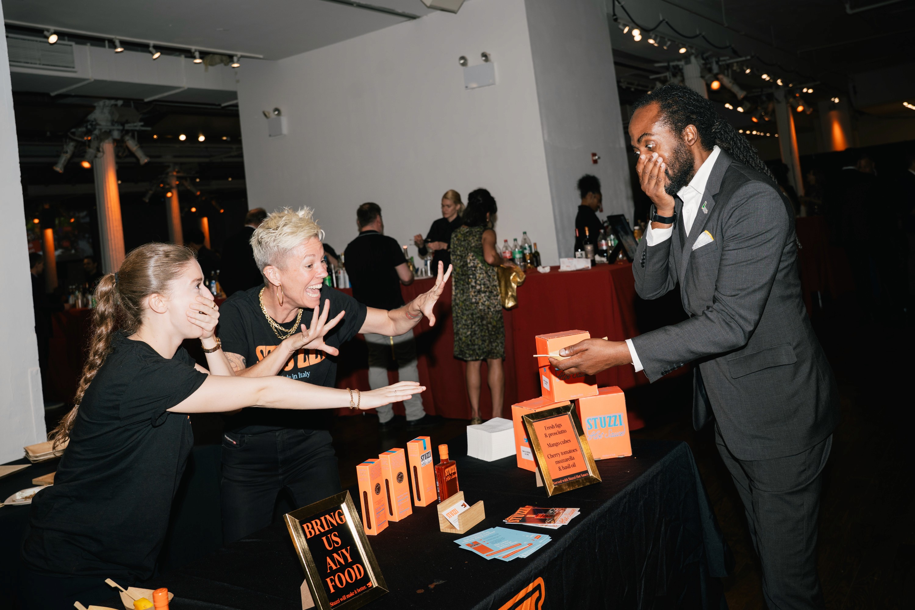 A food vendor and guest react excitedly to a bite of food