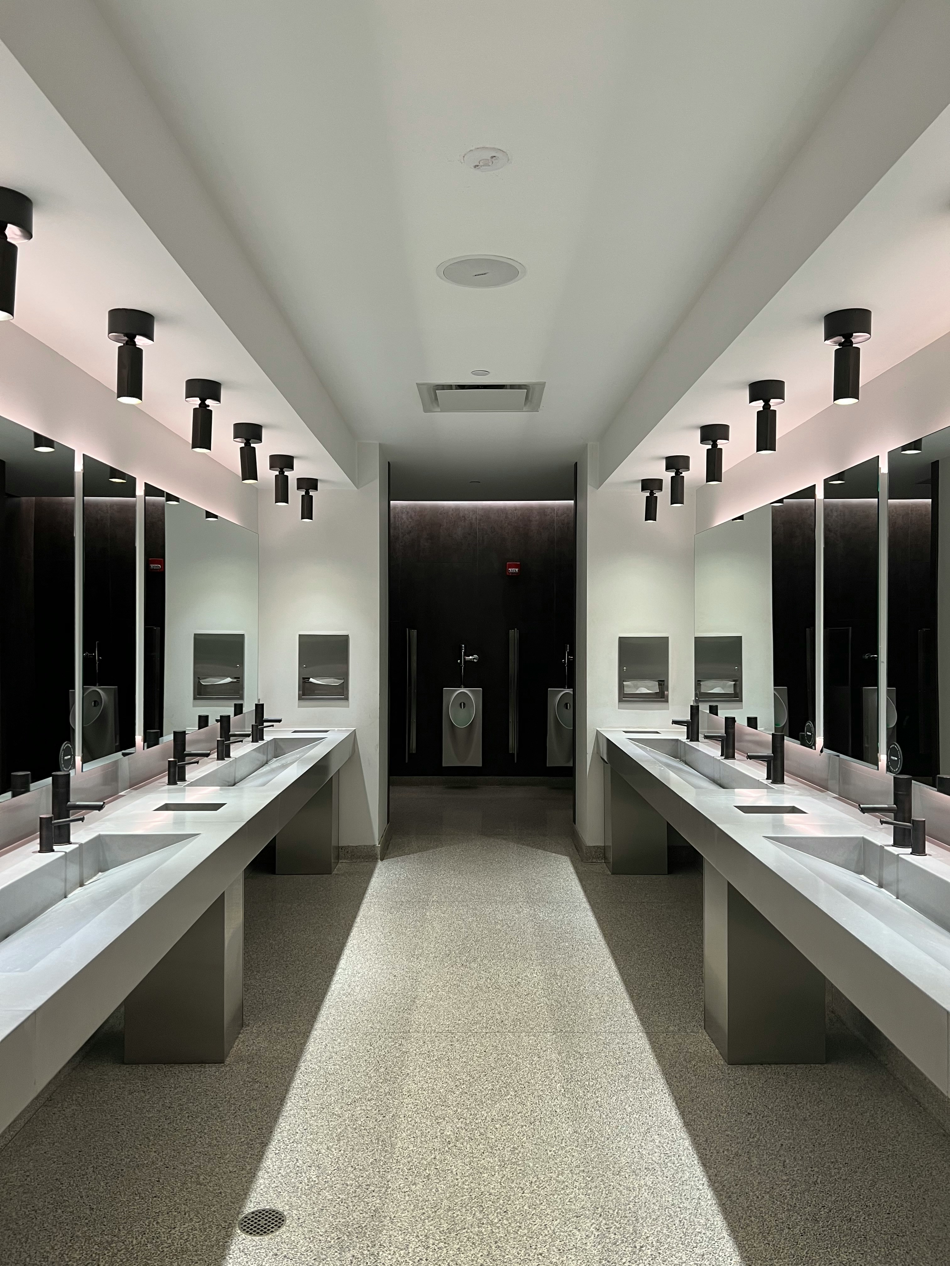 a large bathroom with sinks and mirrors