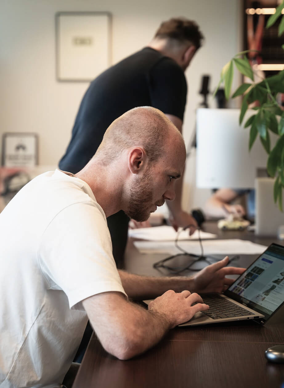 image of a small agency owner running his business on his laptop