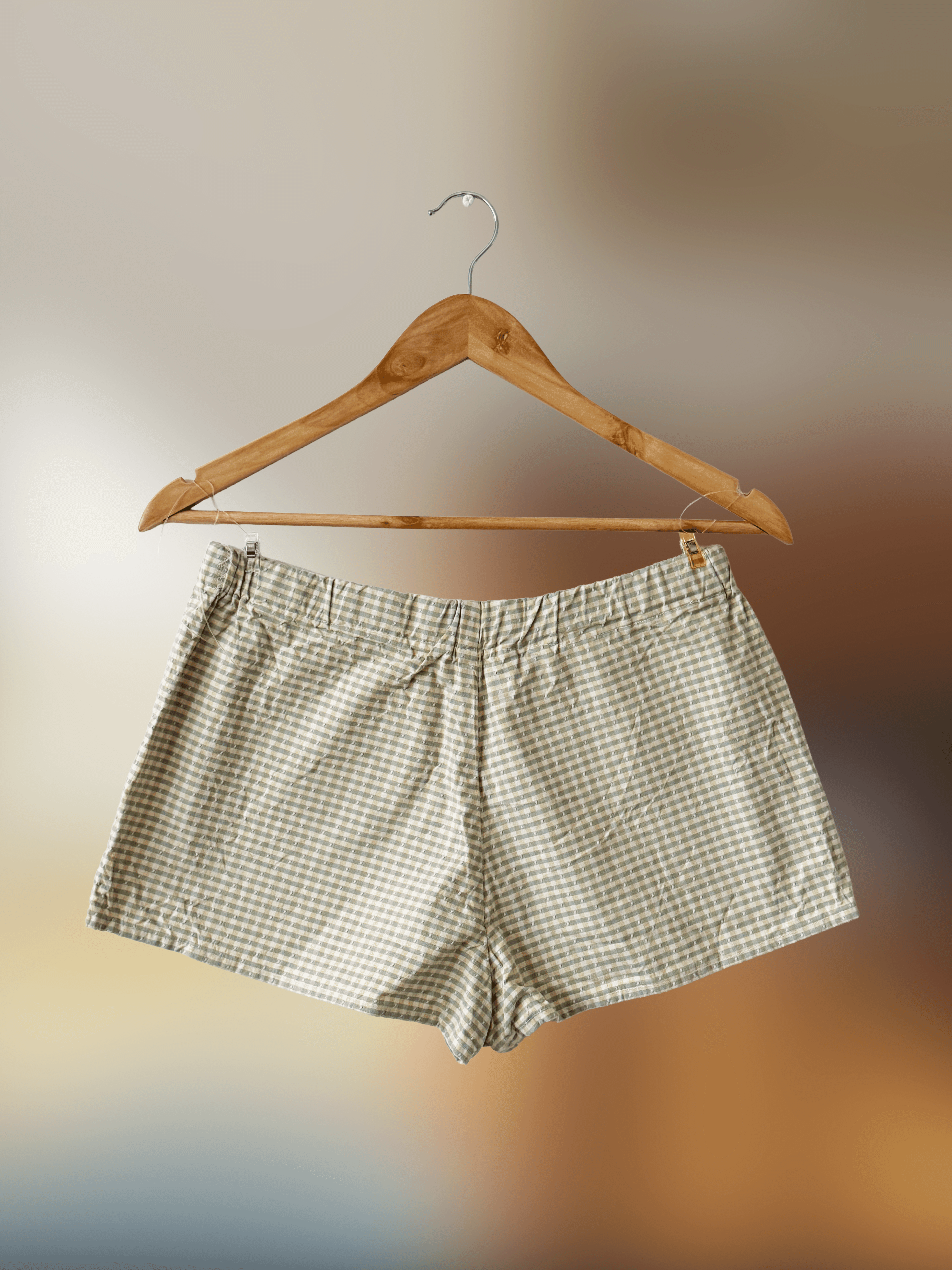 front of yellow and green checkered shorts