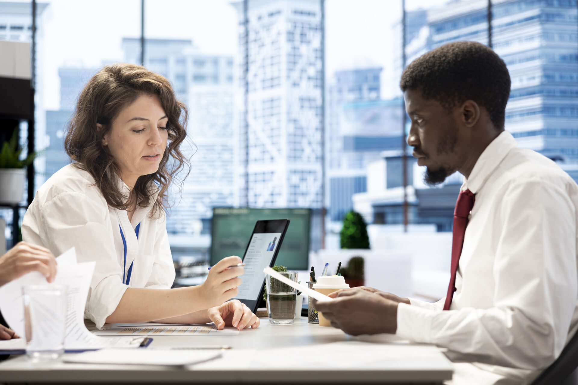 Scientist using a multi-channel pipette to transfer liquid samples in a lab, wearing gloves and surrounded by lab equipment.