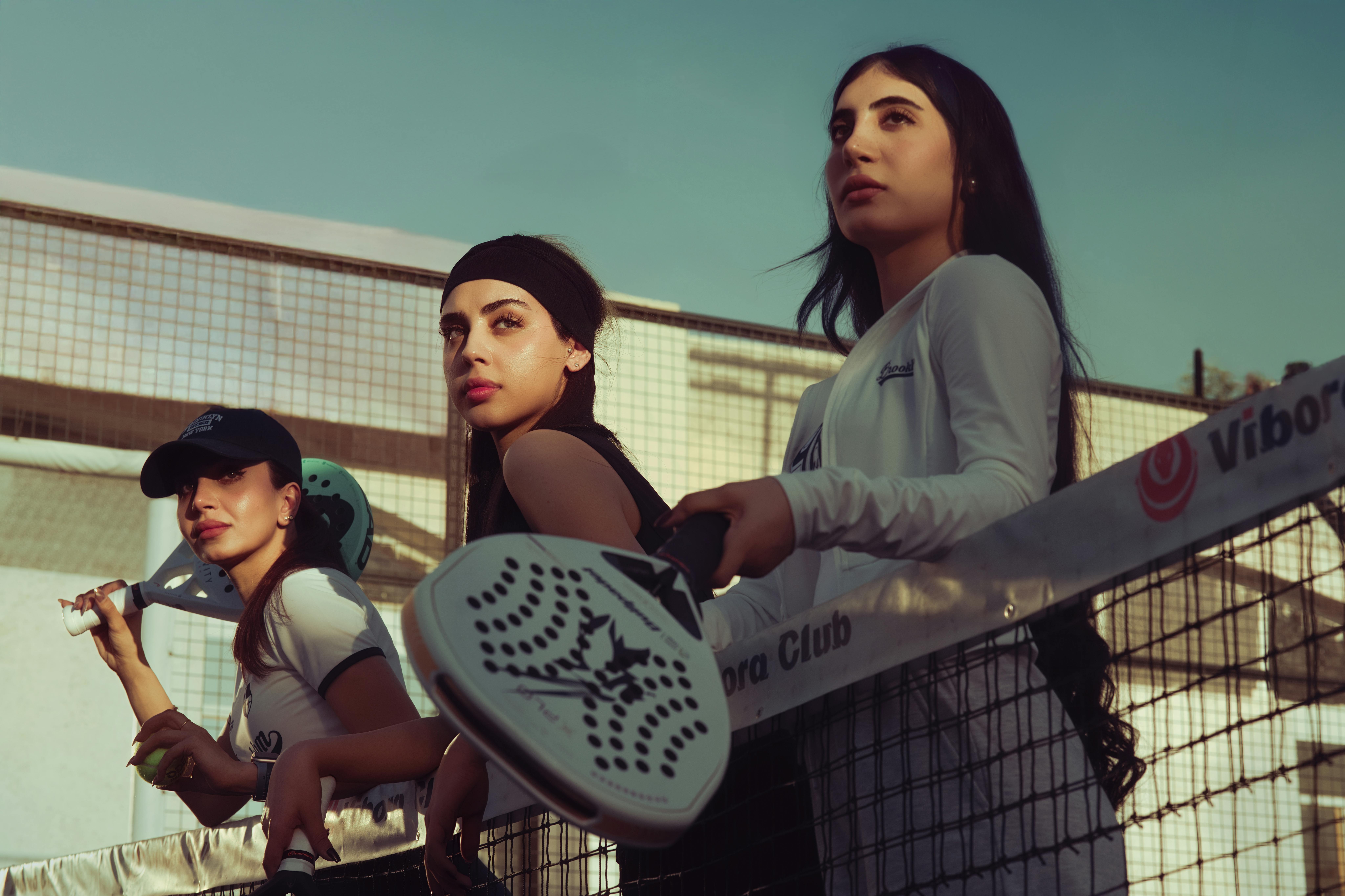 A group of girls holding padel raquets