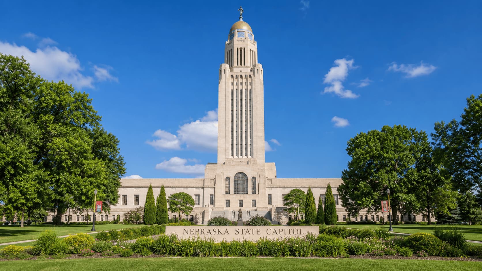 Nebraska State Capitol in Lincoln with tall tower and green surroundings
