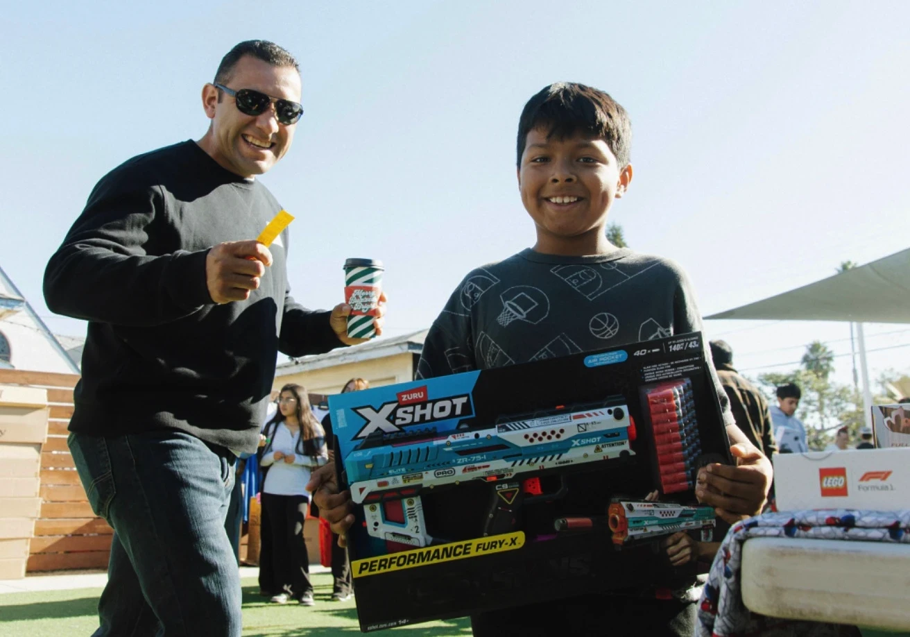 A happy kid shows off his new Nerf gun