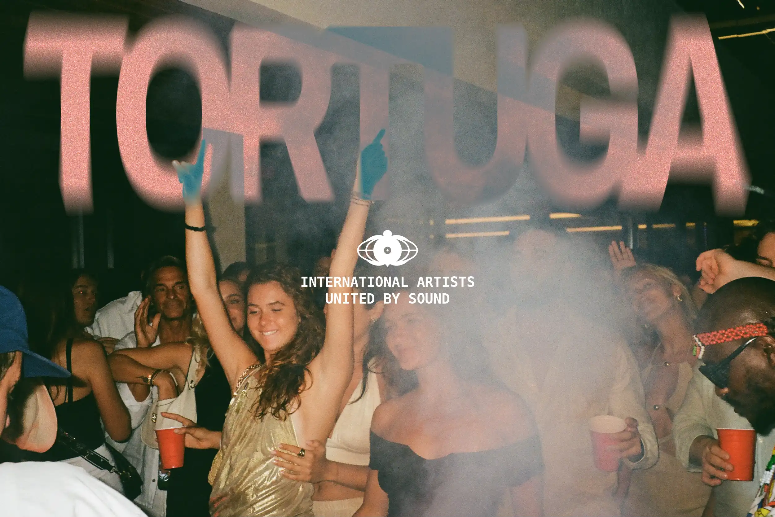 Concert crowd dancing with hands raised, featuring bold Tortuga lettering and “International Artists United by Sound” logo overlay.